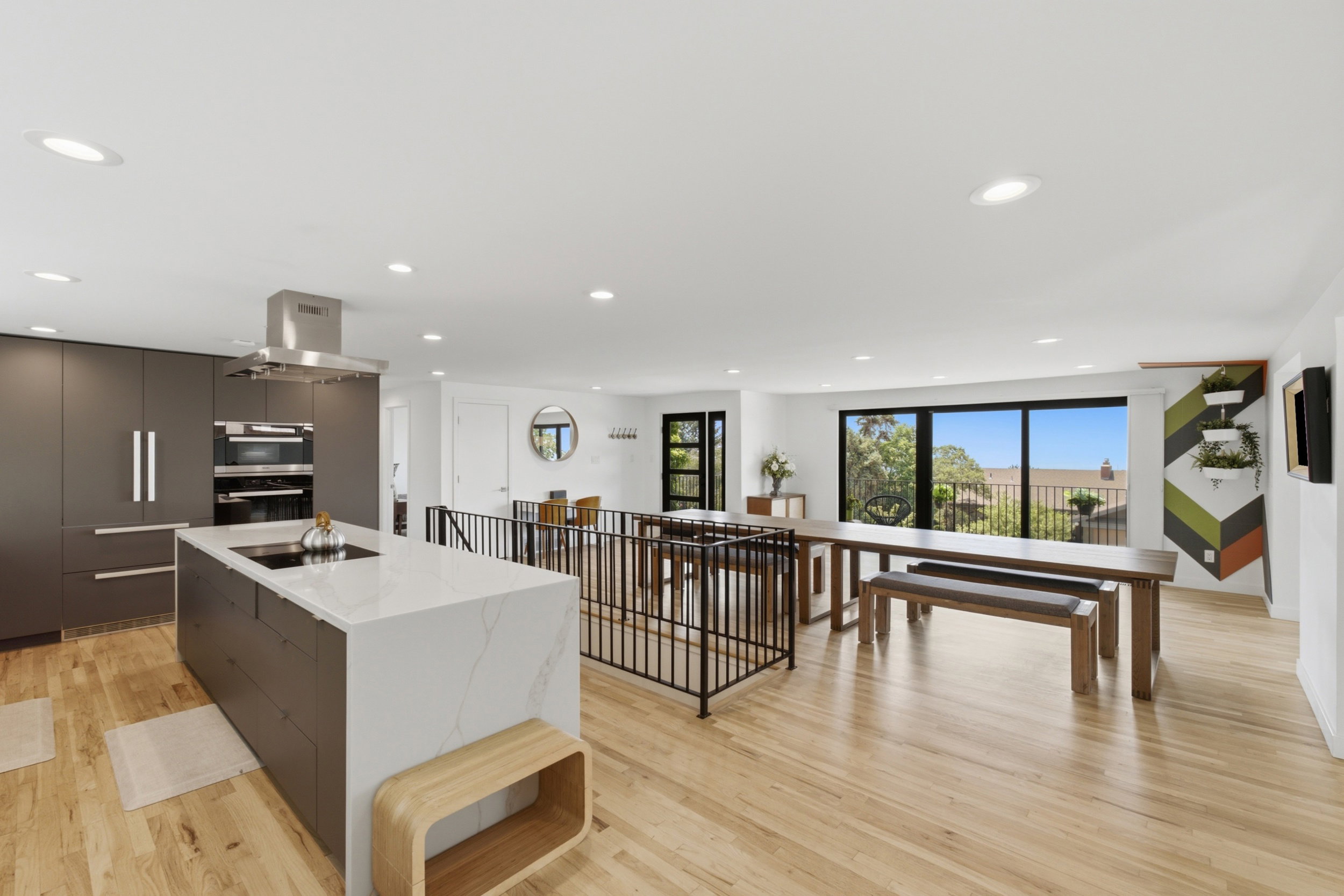 Open-concept living area with light wood-finish flooring