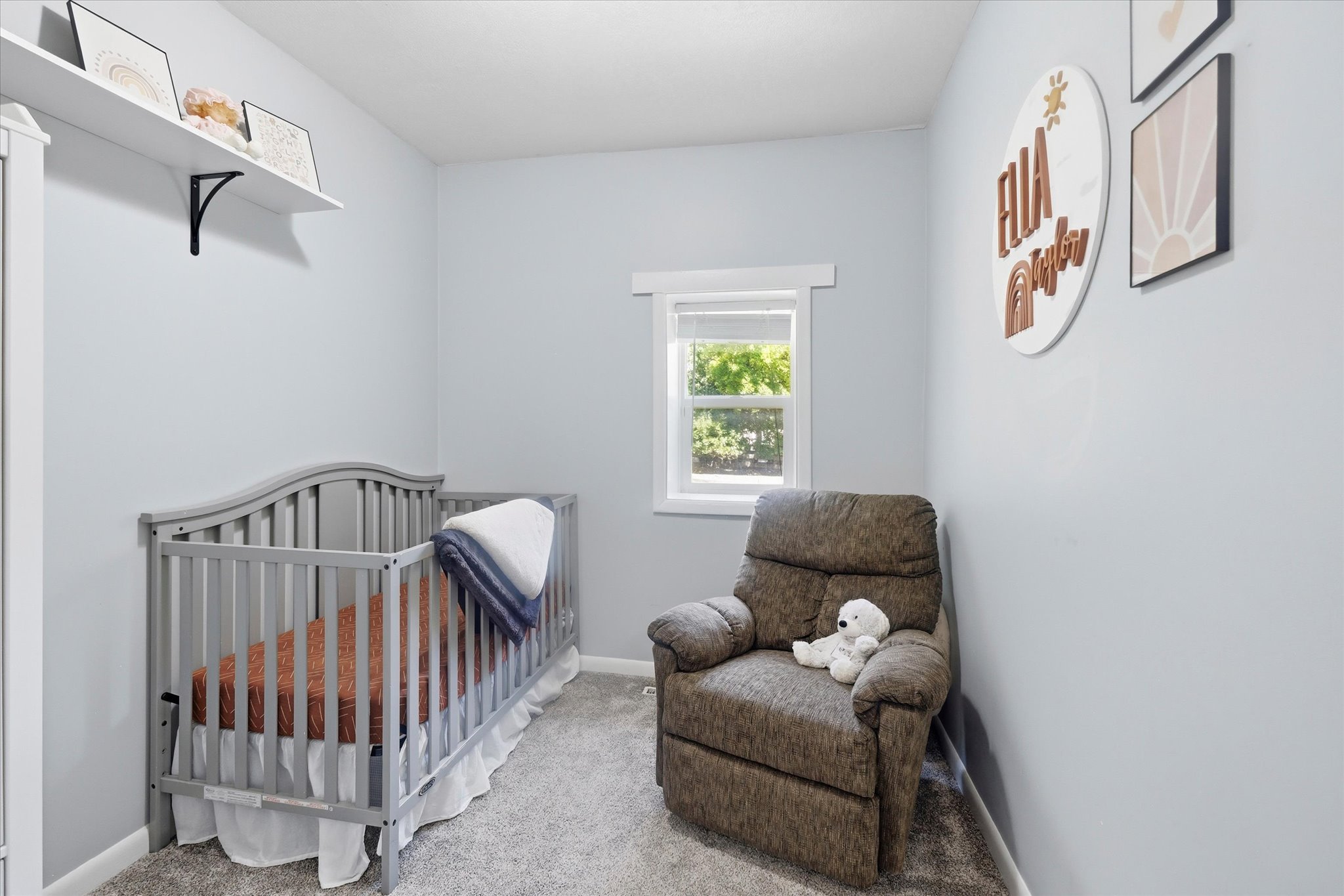 Soft gray wall paint and light gray carpet create a neutral palette for this room
