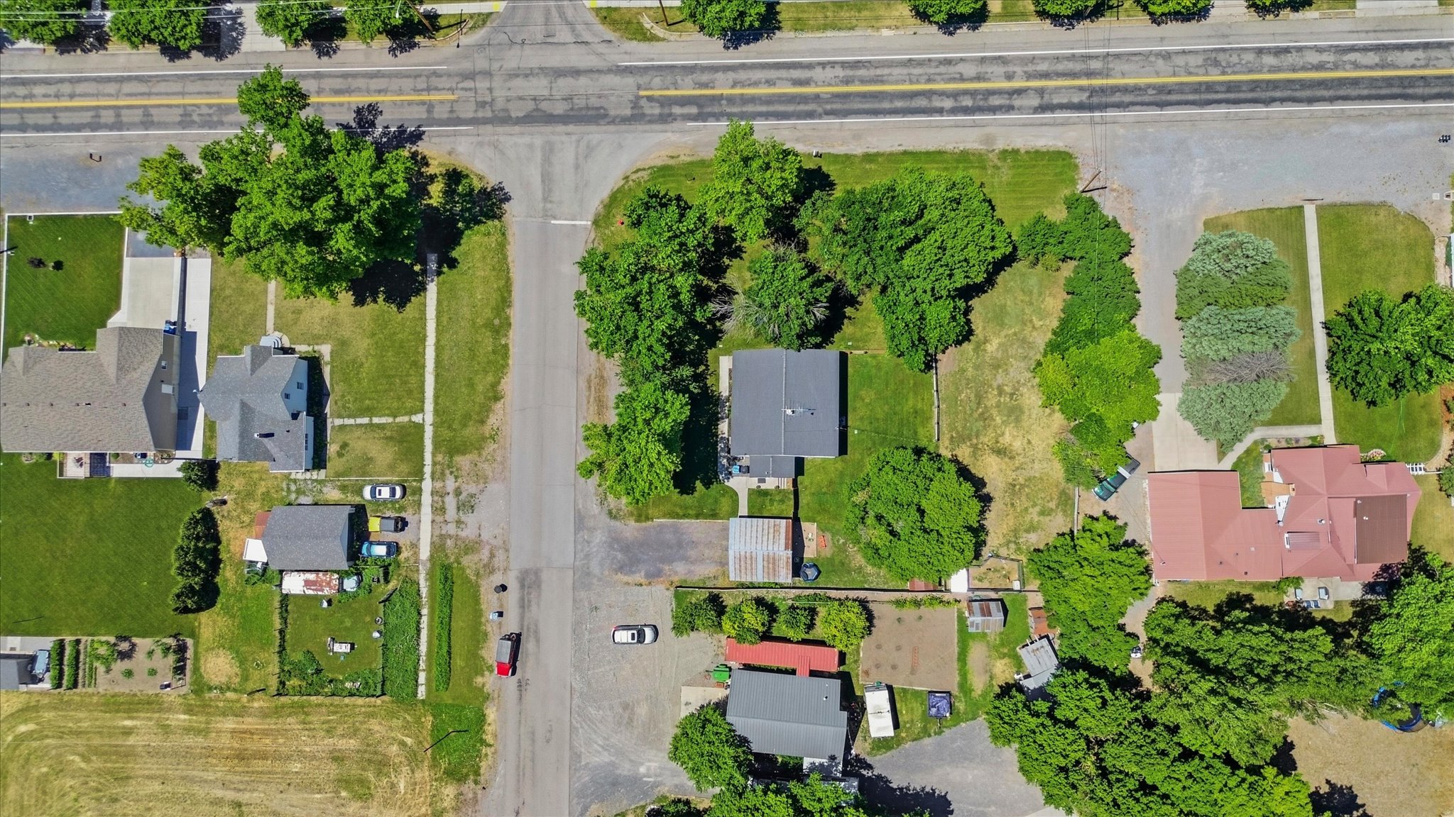 Aerial overview showcasing multiple distinct properties, each featuring mature landscaping and varying architectural styles