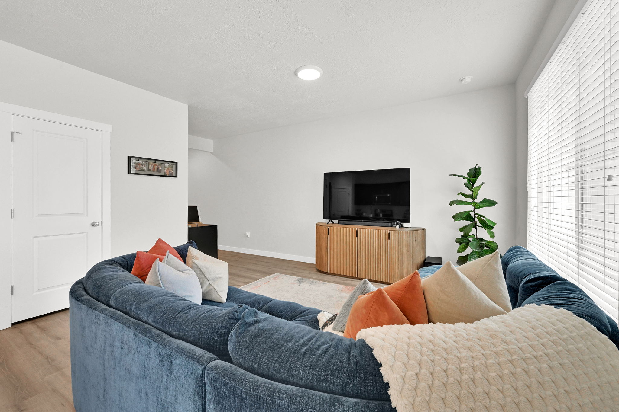 Living area featuring wood-finish flooring and white walls