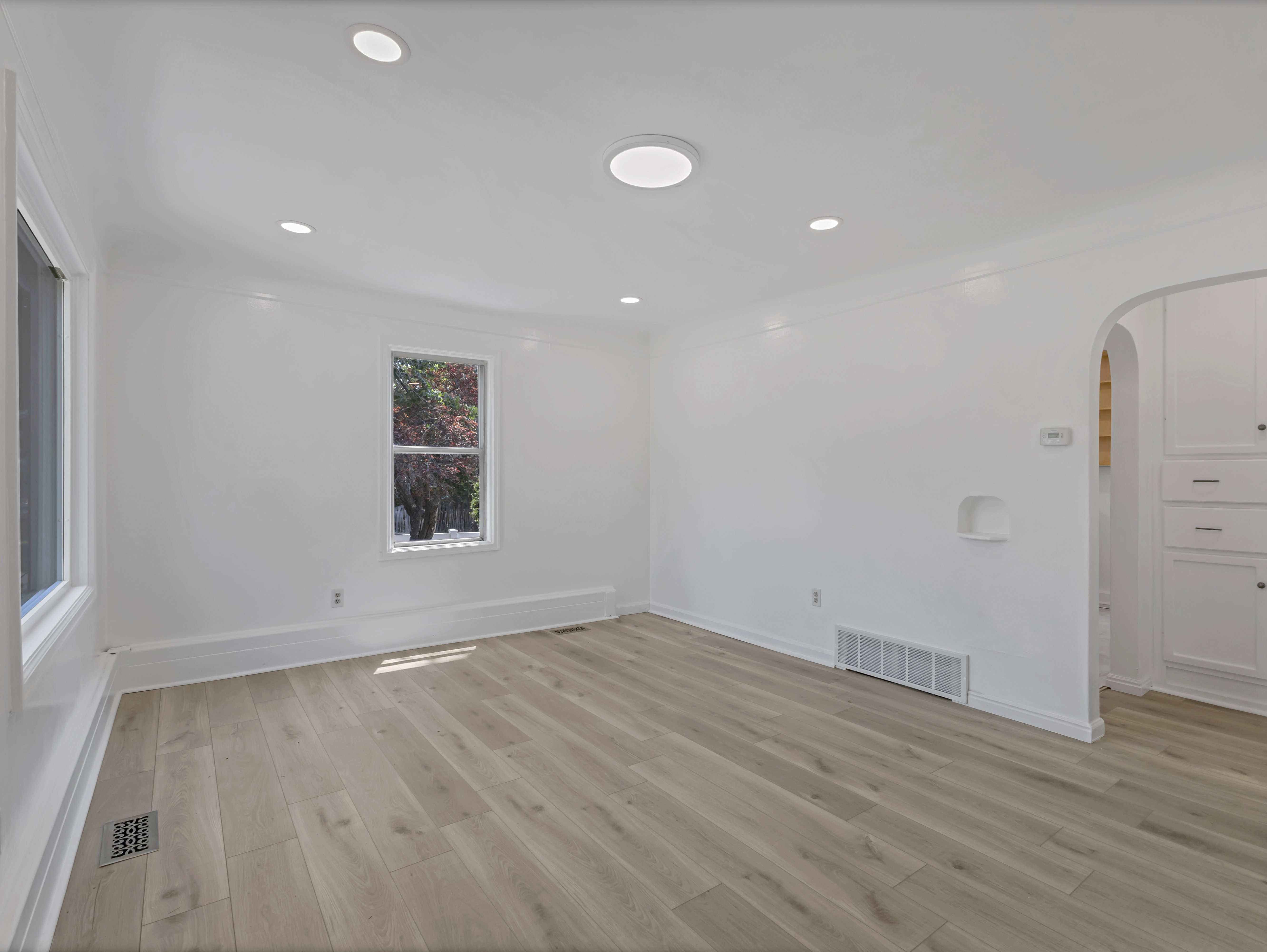Spacious interior with neutral wall tones and light wood-finish flooring