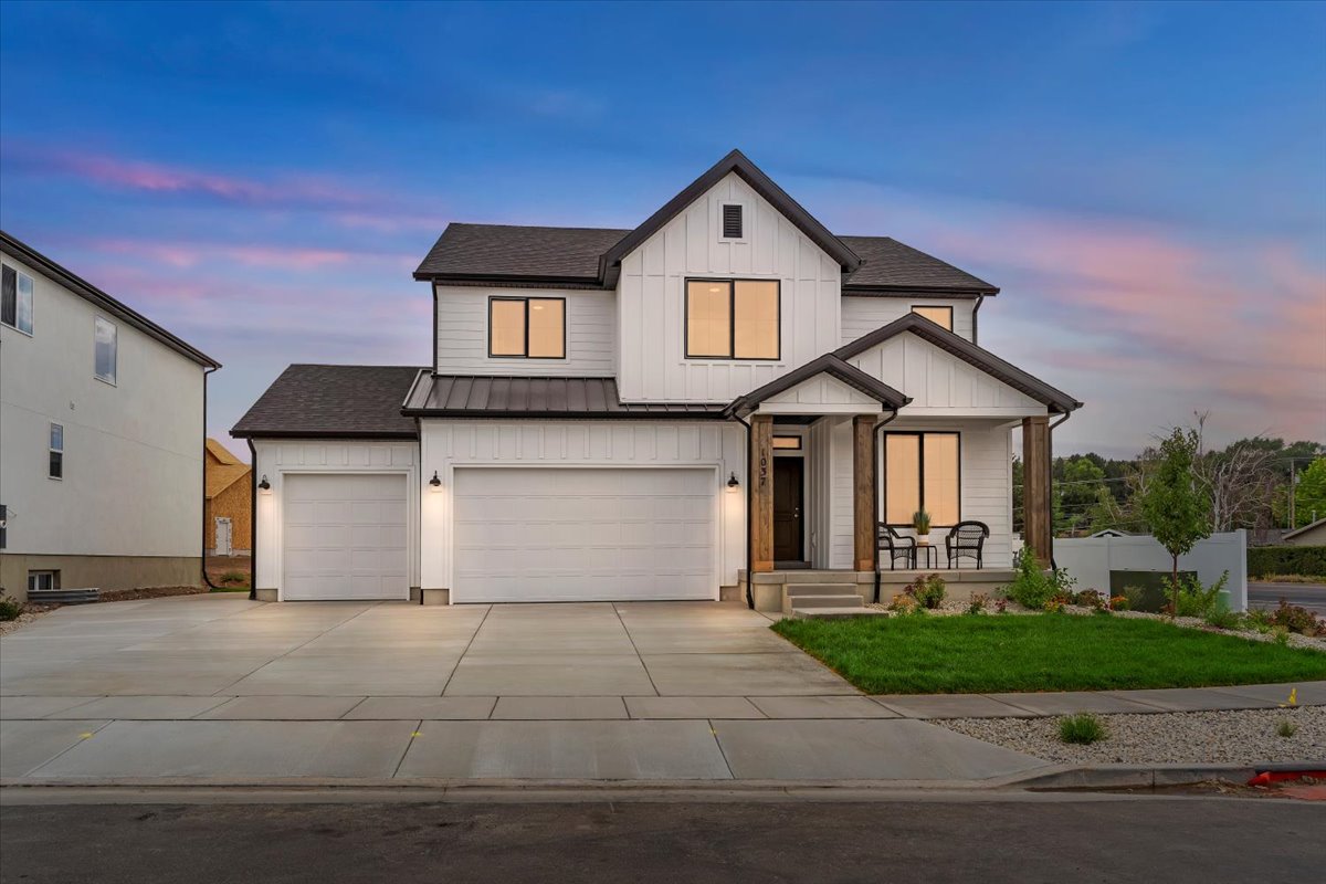 Modern farmhouse exterior with white vertical siding and dark trim