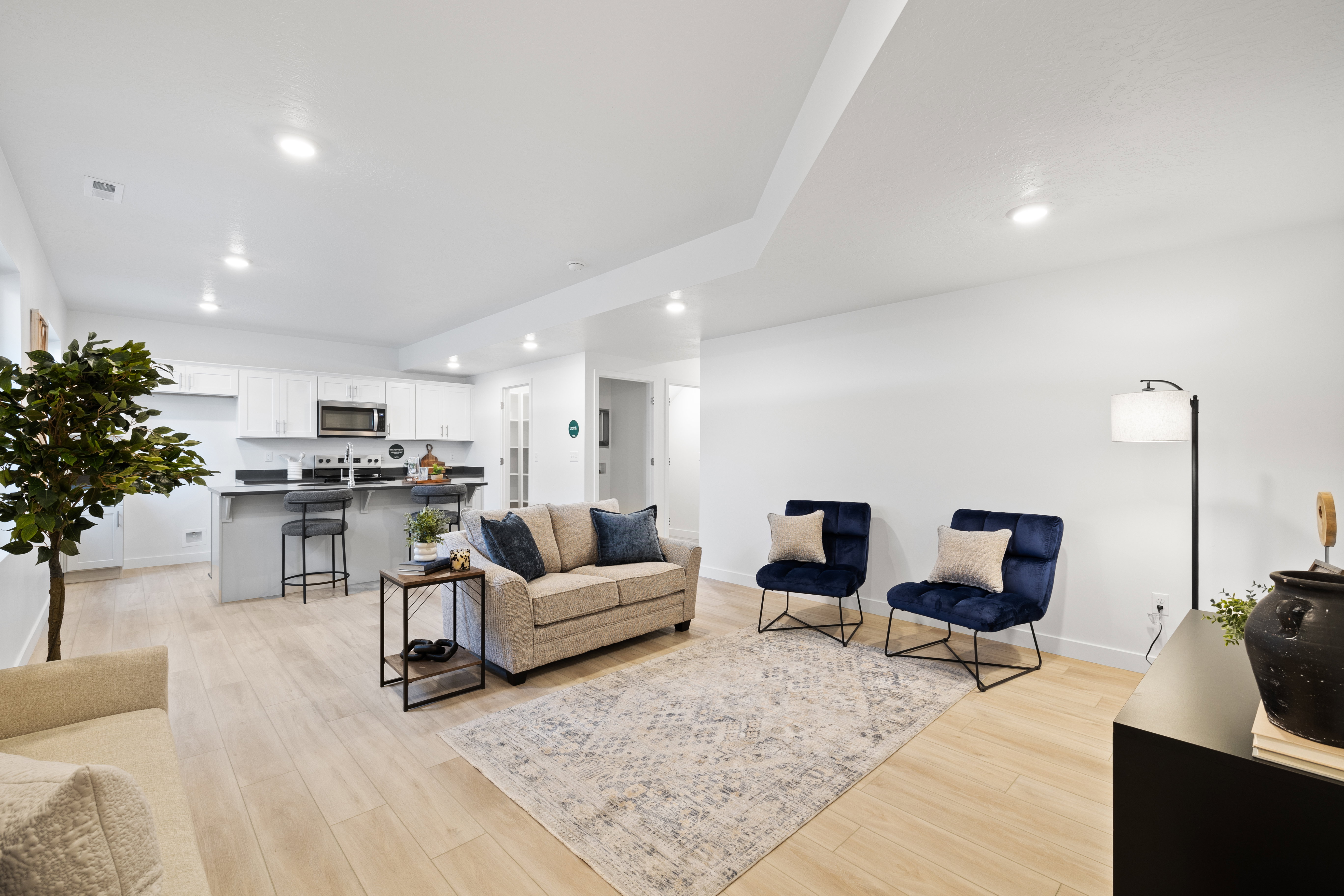 Open-concept living space featuring wood-finish flooring and recessed lighting