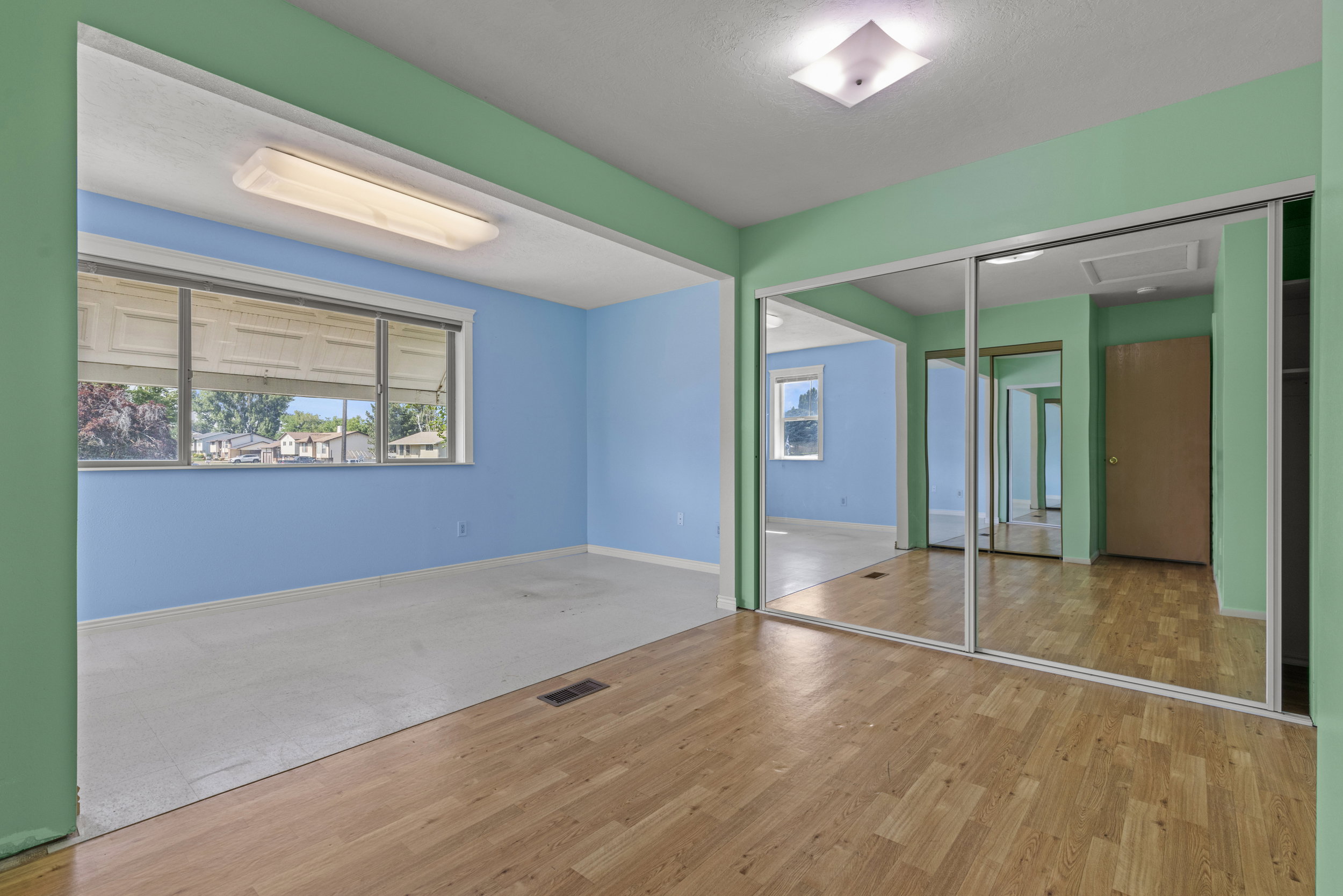 Interior space featuring wood-finish flooring, mirrored closet doors, and recessed lighting