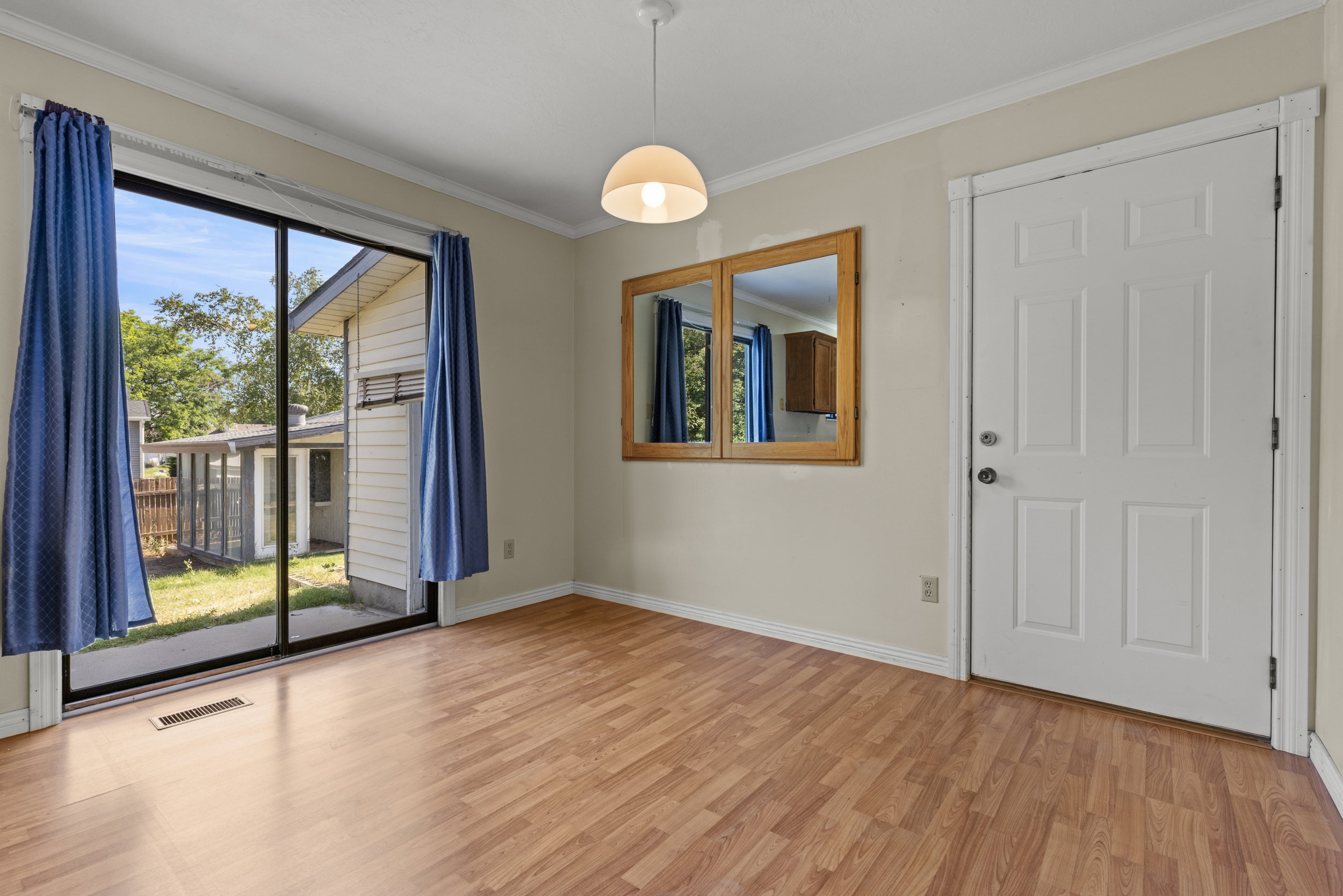 Interior space featuring wood-finish flooring, light-colored walls, and white trim