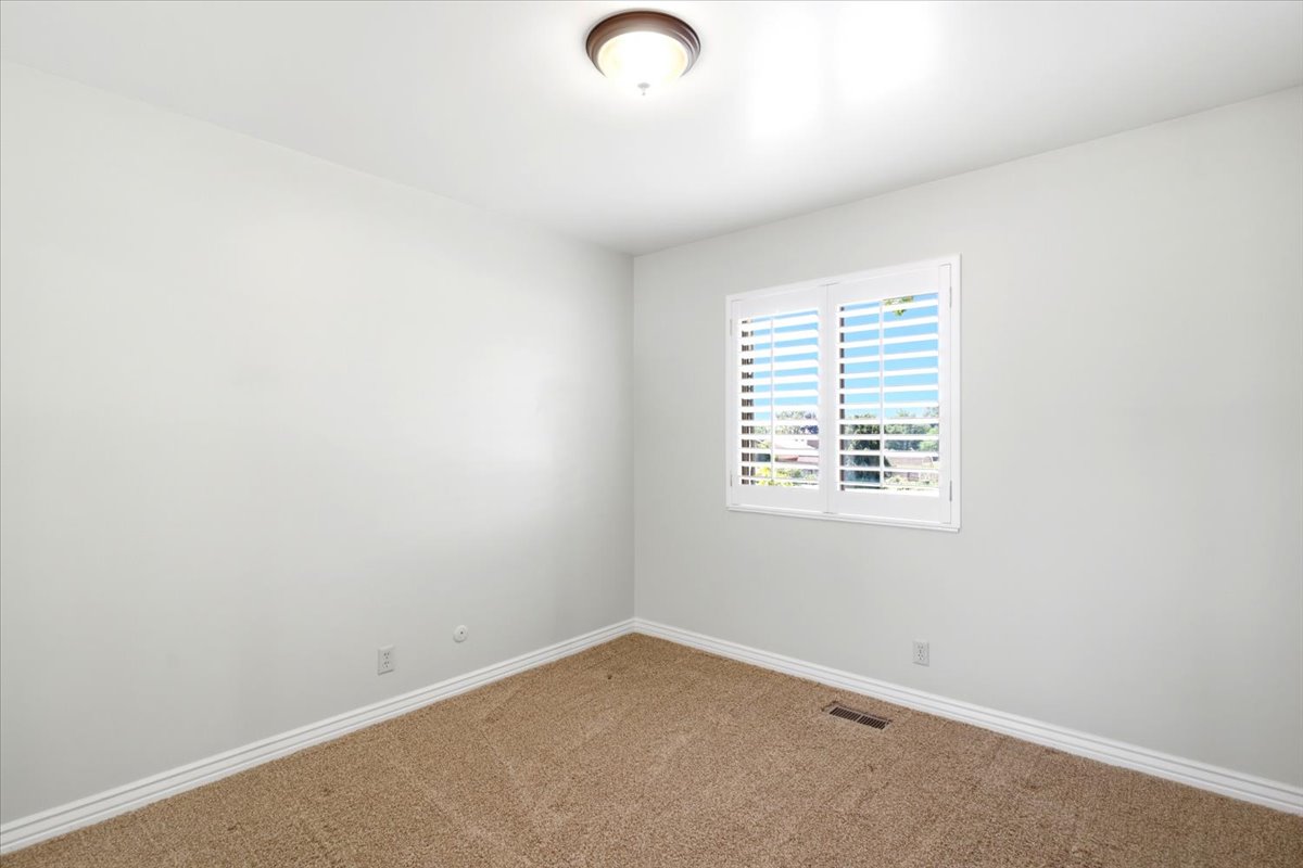 Neutral wall finishes with a ceiling-mounted light fixture