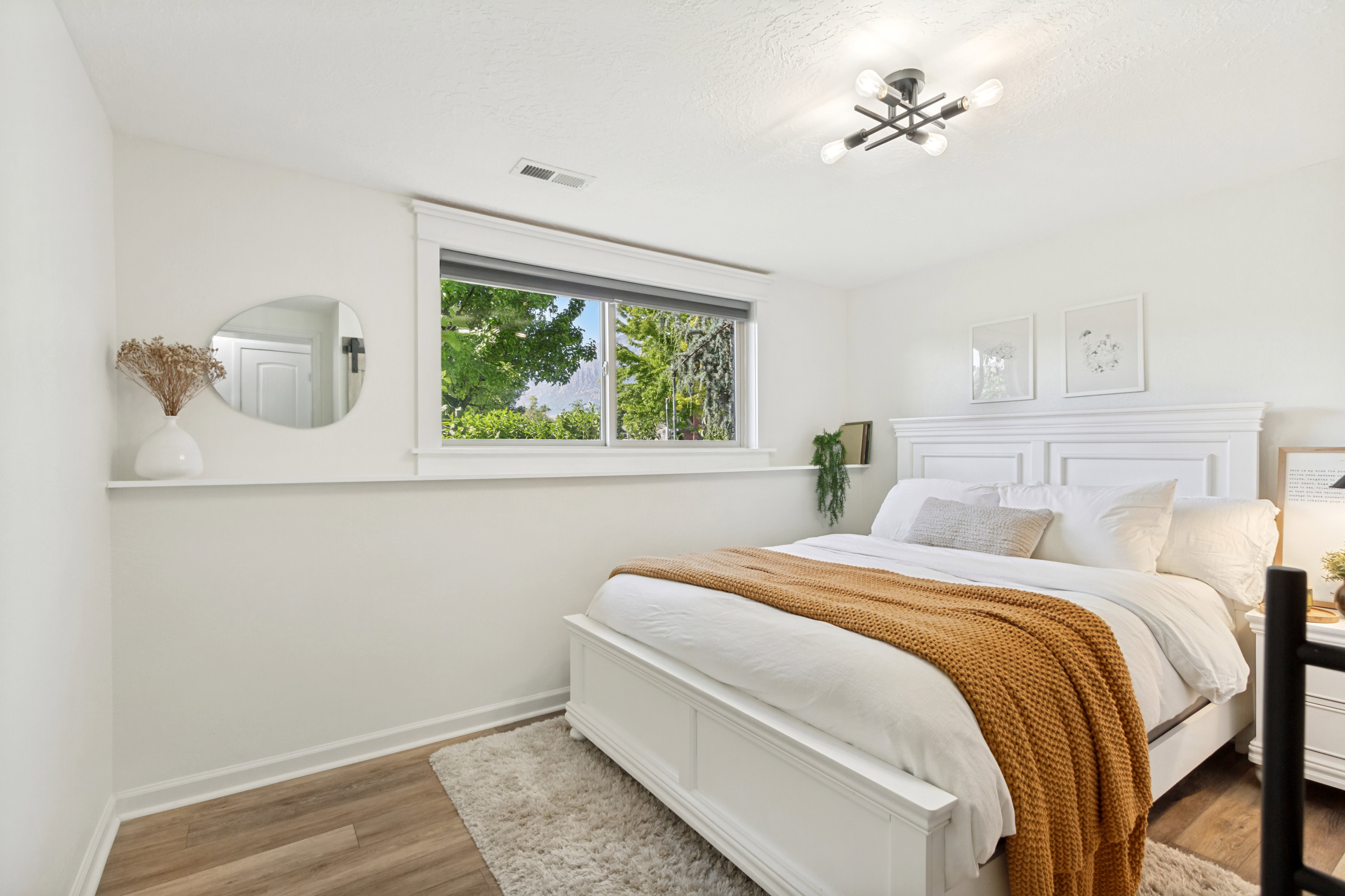 Bright interior featuring wood-finish flooring and a contemporary ceiling light fixture