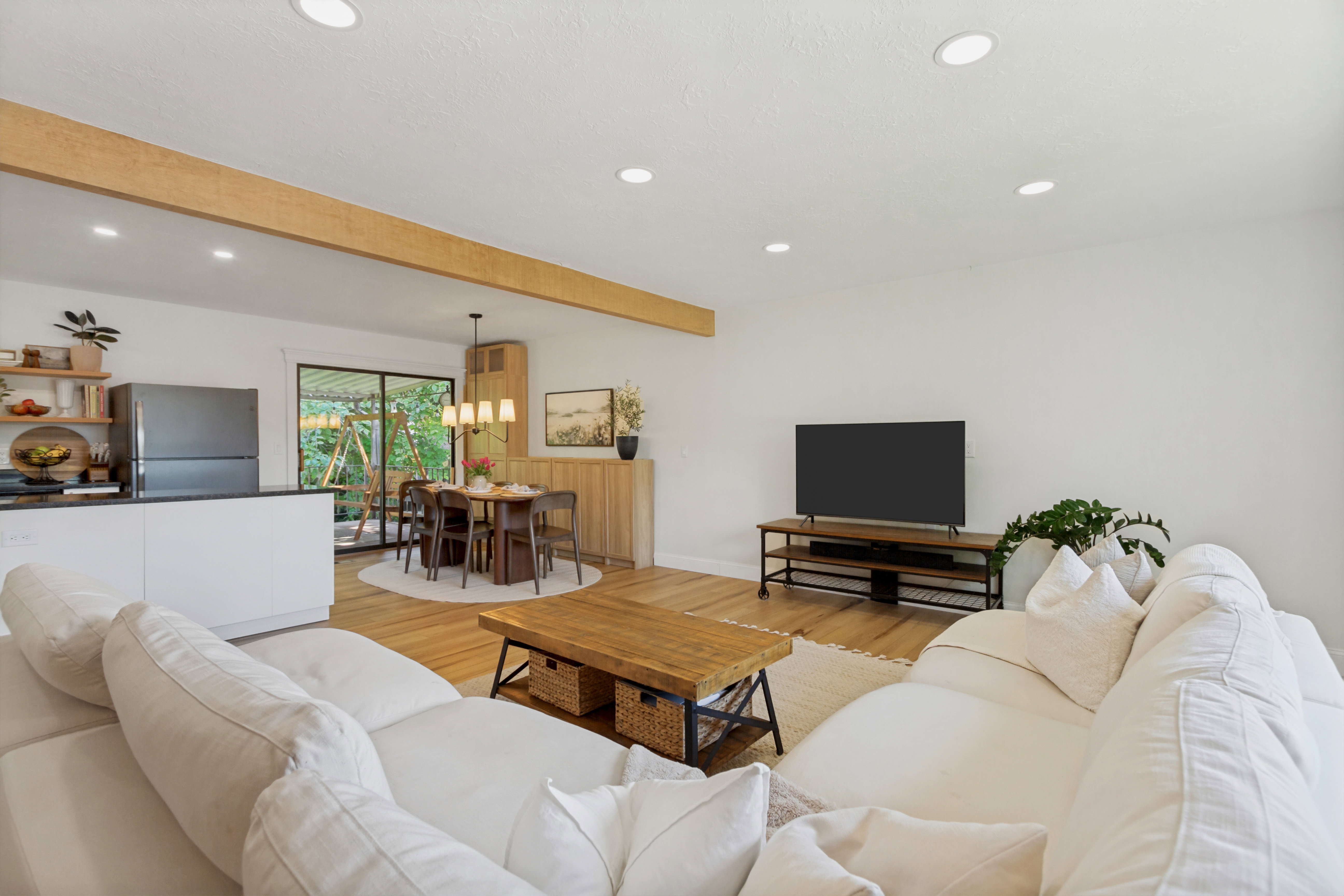 Open-concept living area featuring light wood-finish flooring and recessed lighting