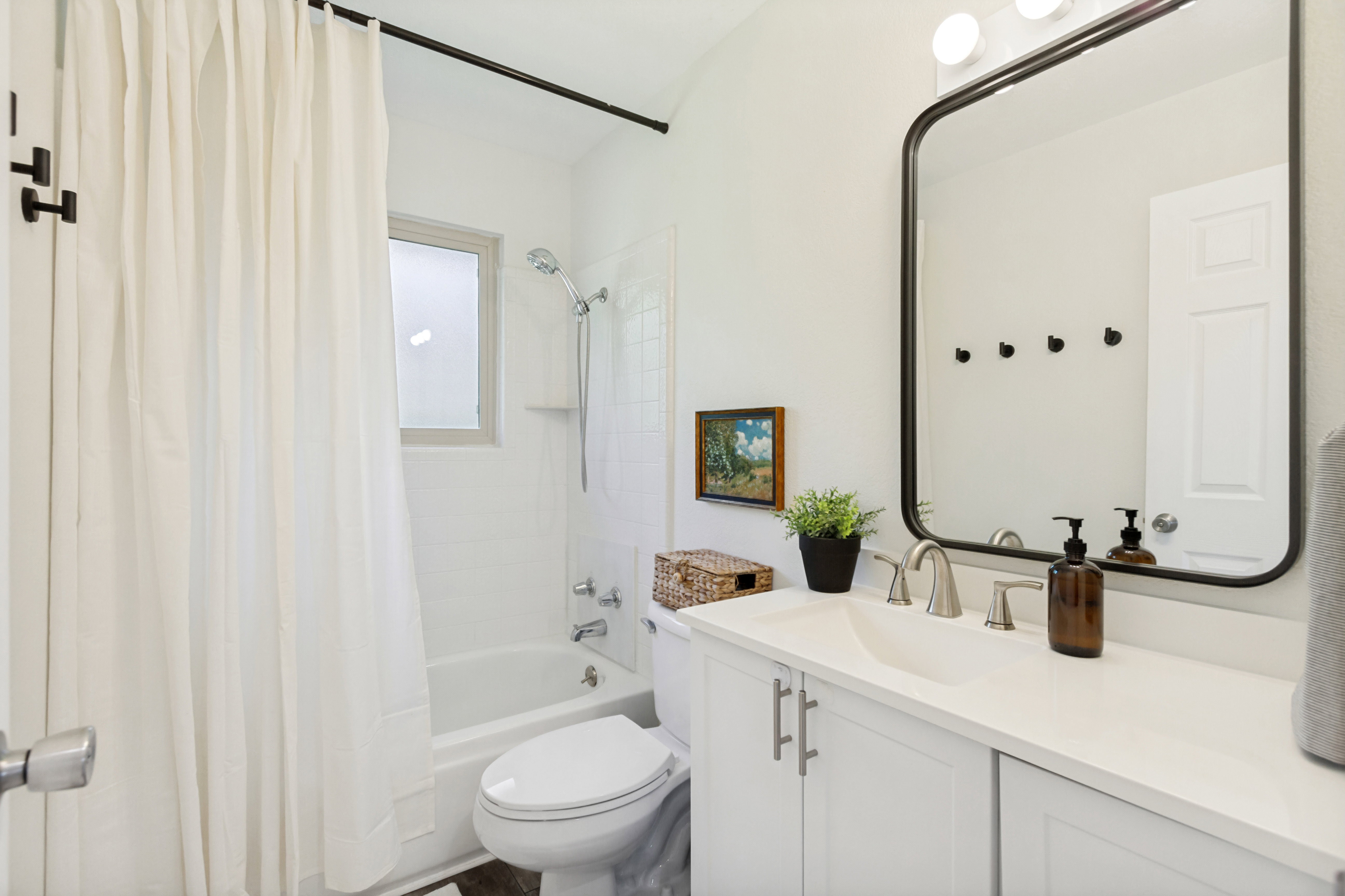 Vanity with integrated sink, white countertop, and brushed nickel faucet set