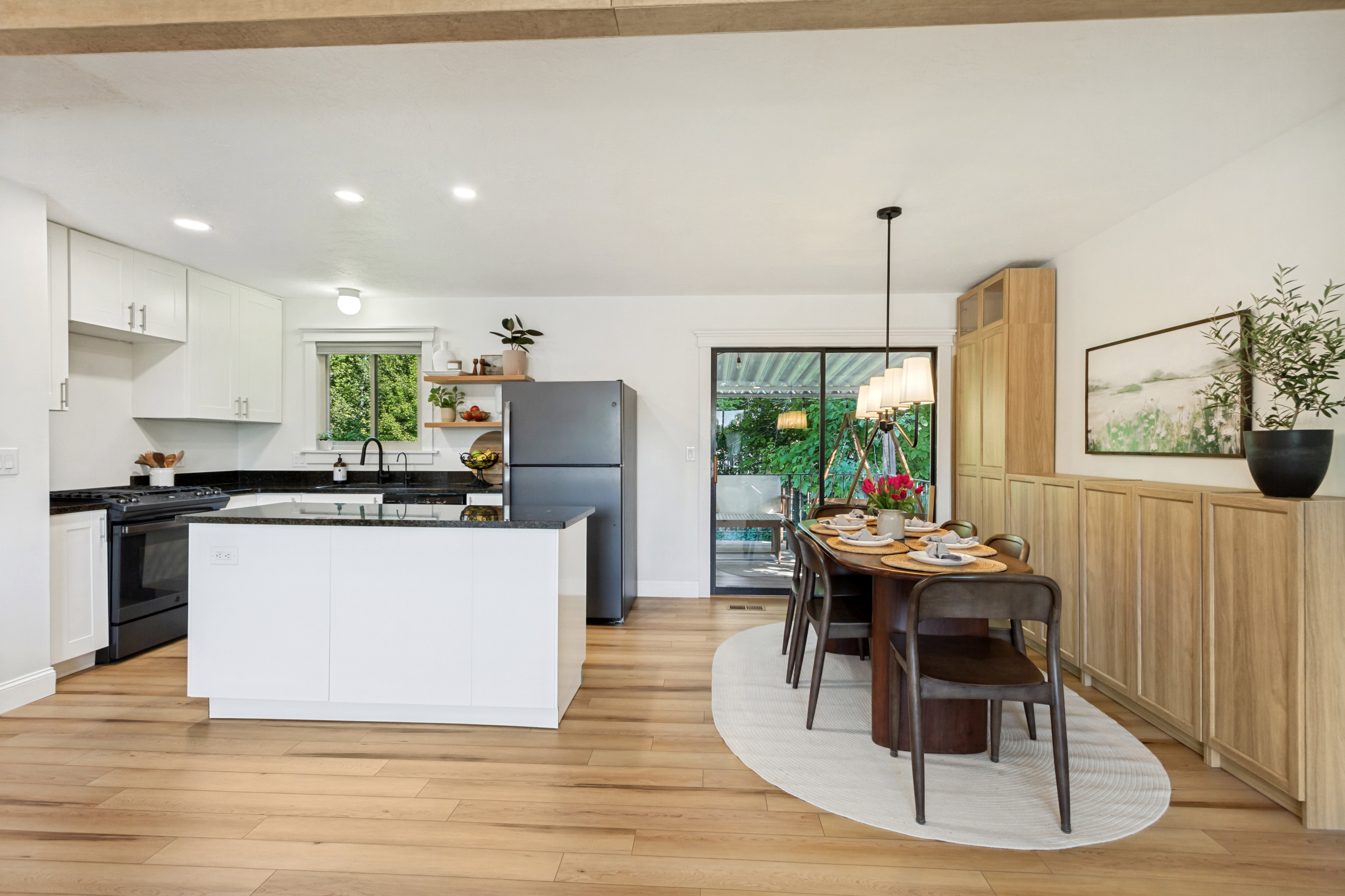Open-concept kitchen and dining area featuring light wood-finish flooring