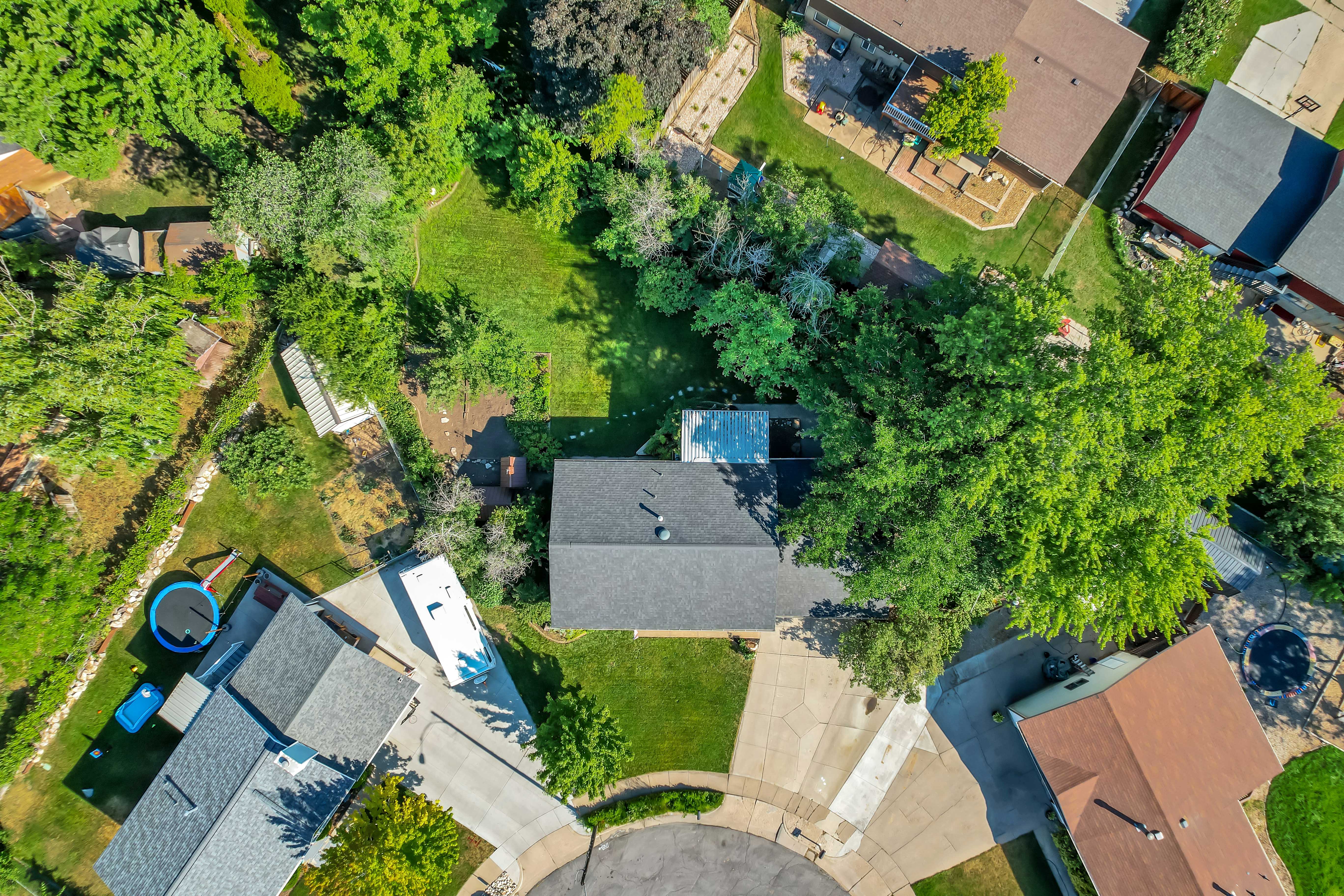 Large residential lot featuring mature trees, a cul-de-sac location, and a spacious backyard