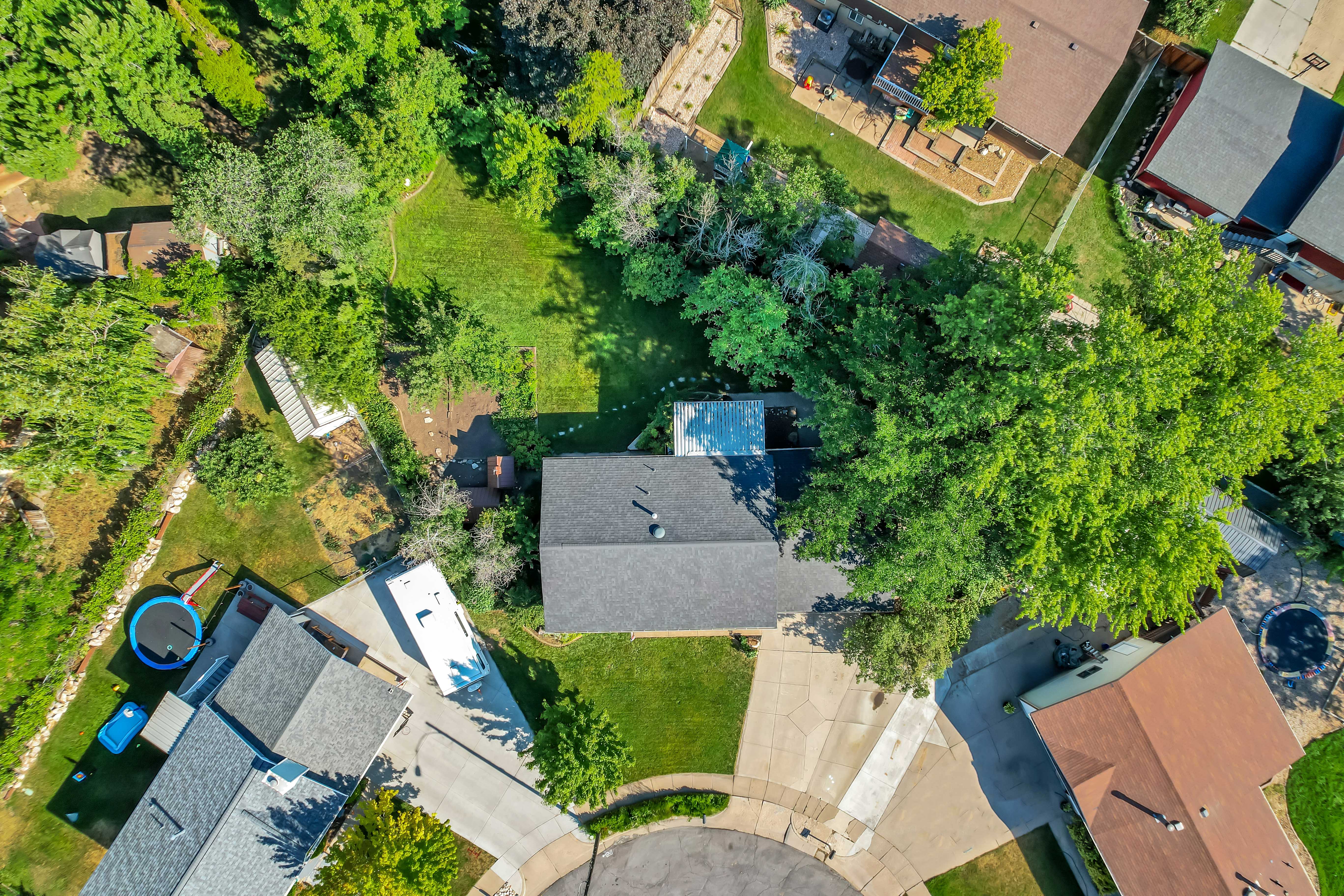 Aerial perspective showcasing a cul-de-sac property with mature trees providing ample shade
