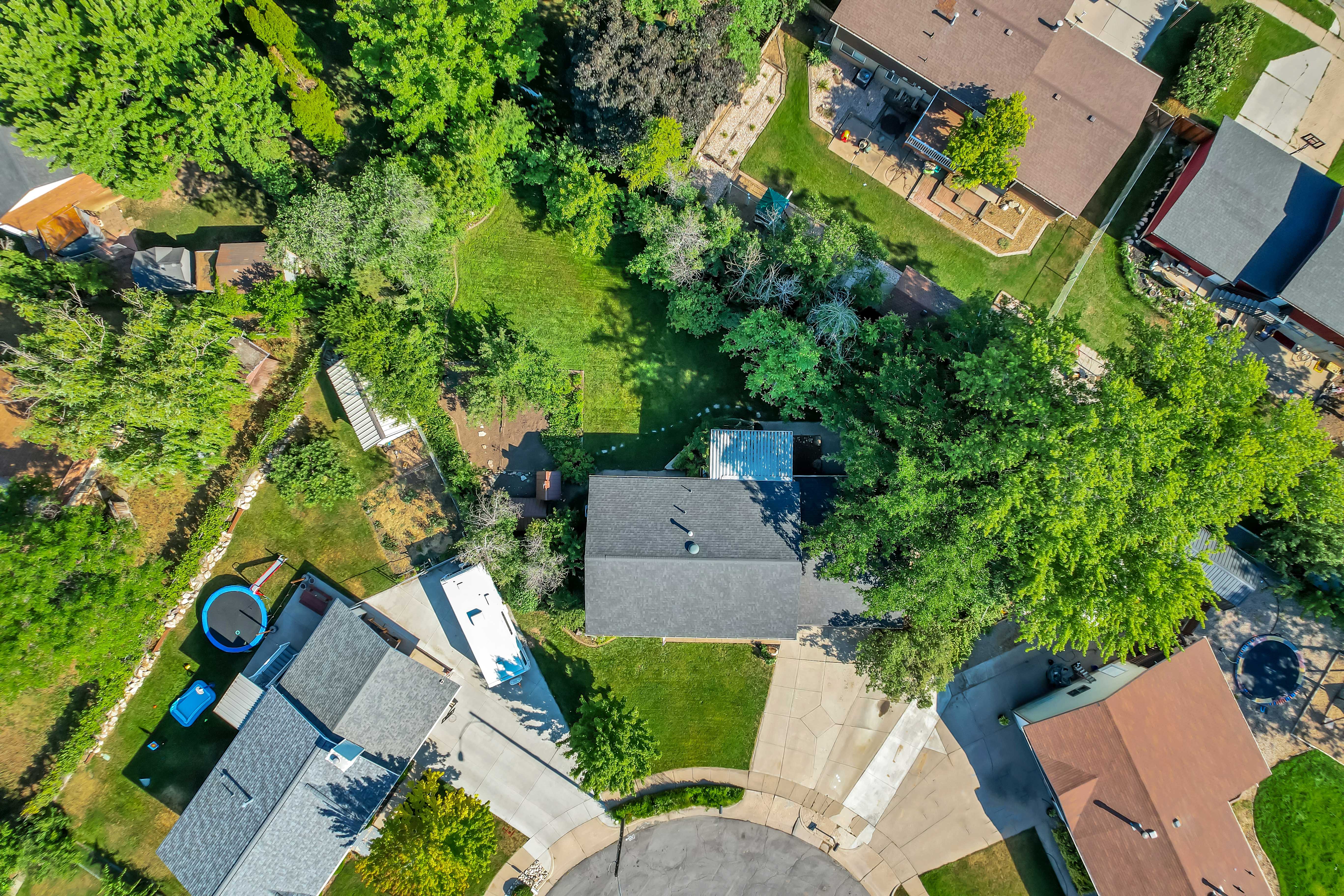 Expansive lot featuring mature trees, a cul-de-sac location, and a paved driveway