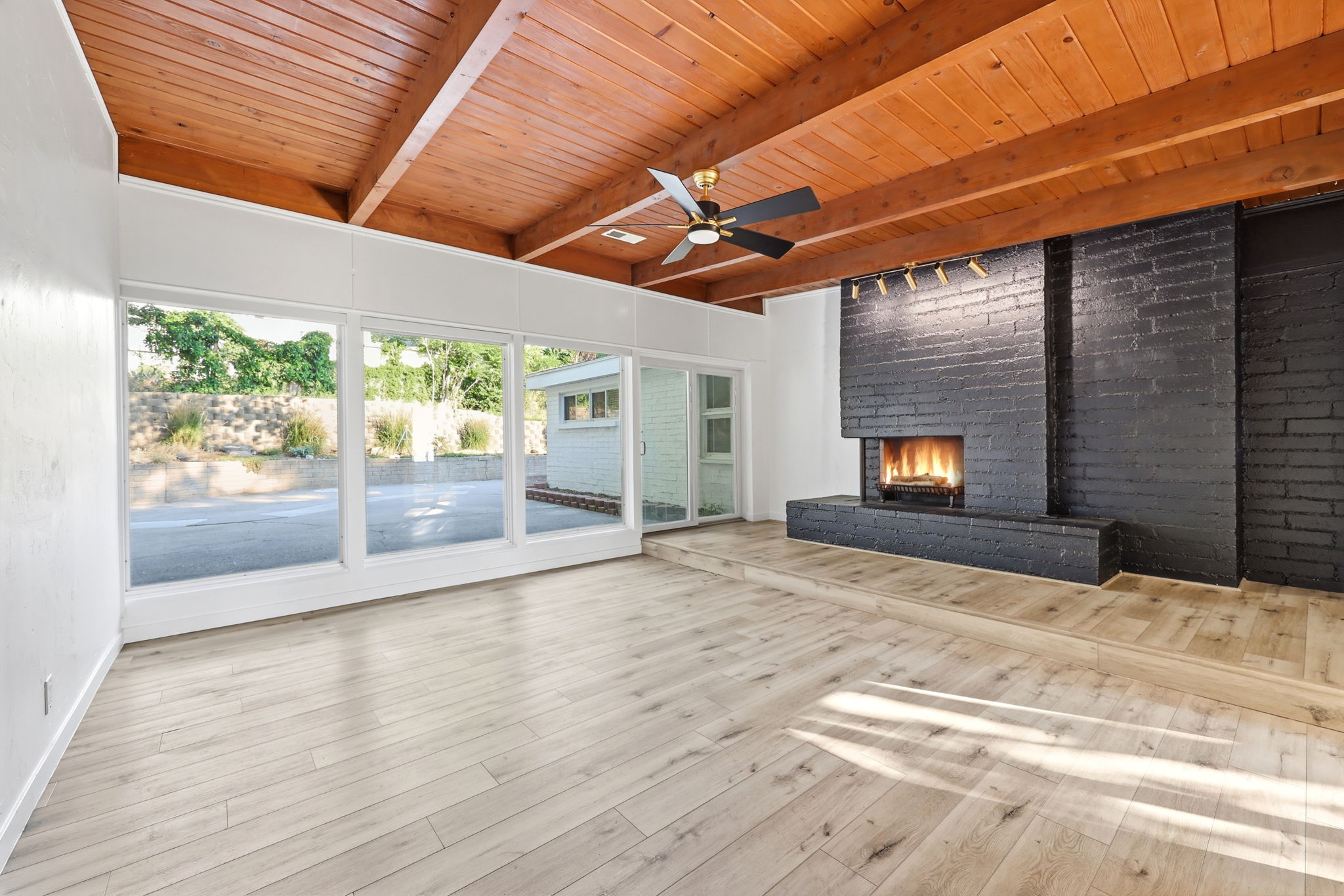 Vaulted wood-beam ceiling with a ceiling fan