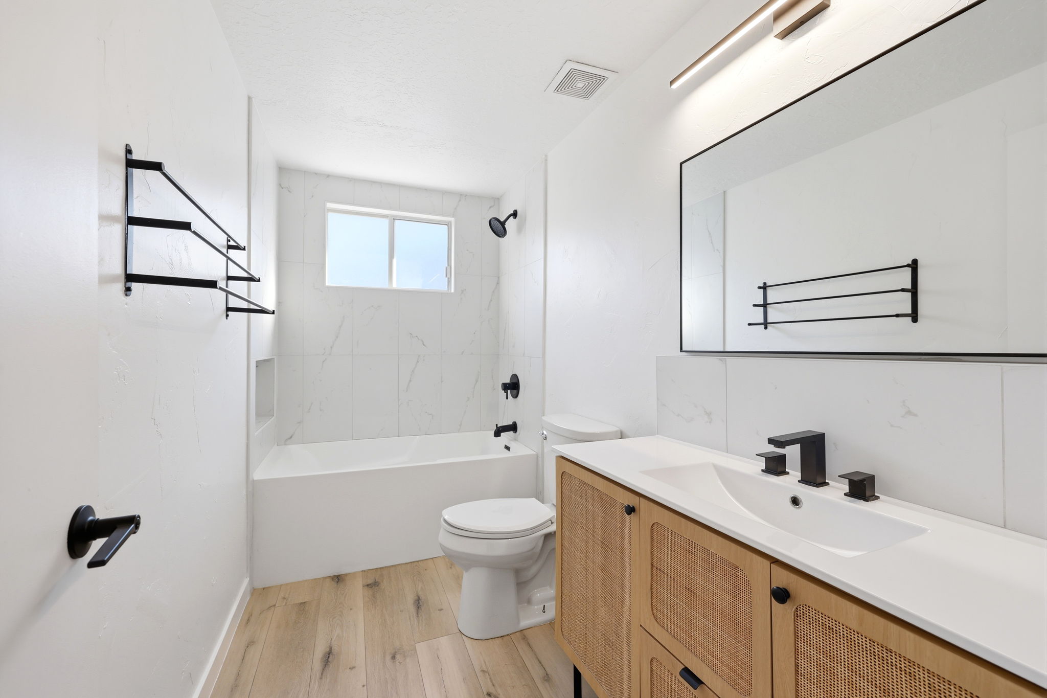 Bathroom featuring a contemporary vanity with a white countertop and integrated sink