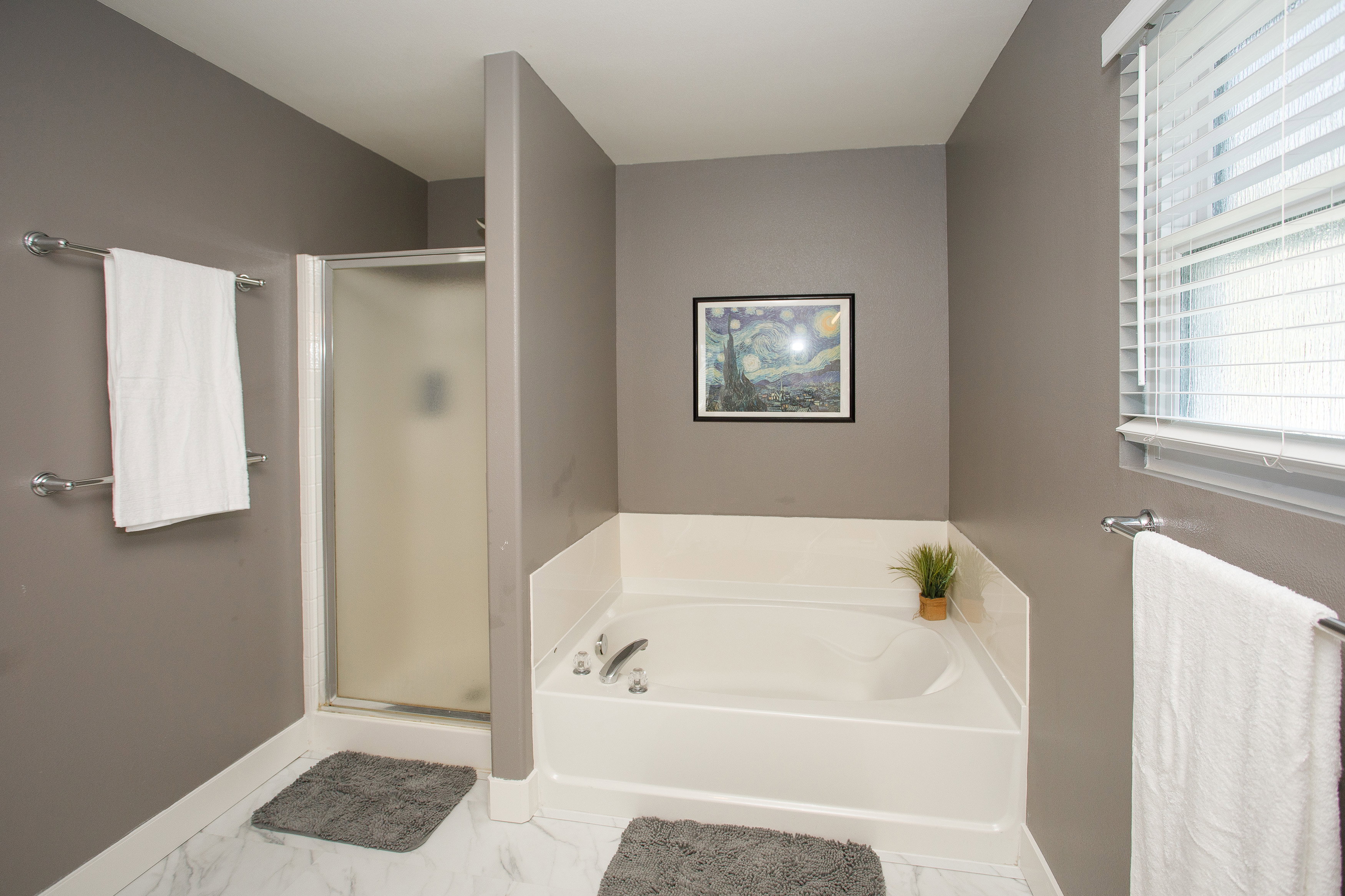 Bathroom featuring a built-in soaking tub and a glass-enclosed shower