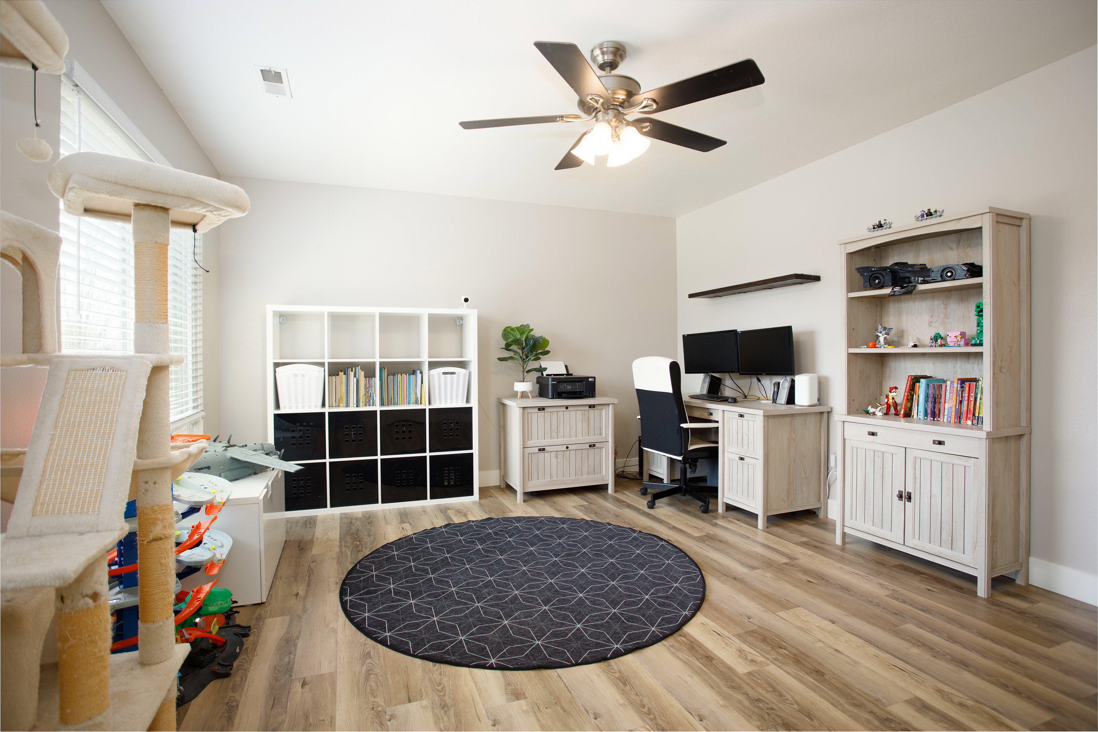 Spacious room with sloped ceilings and wood-finish flooring