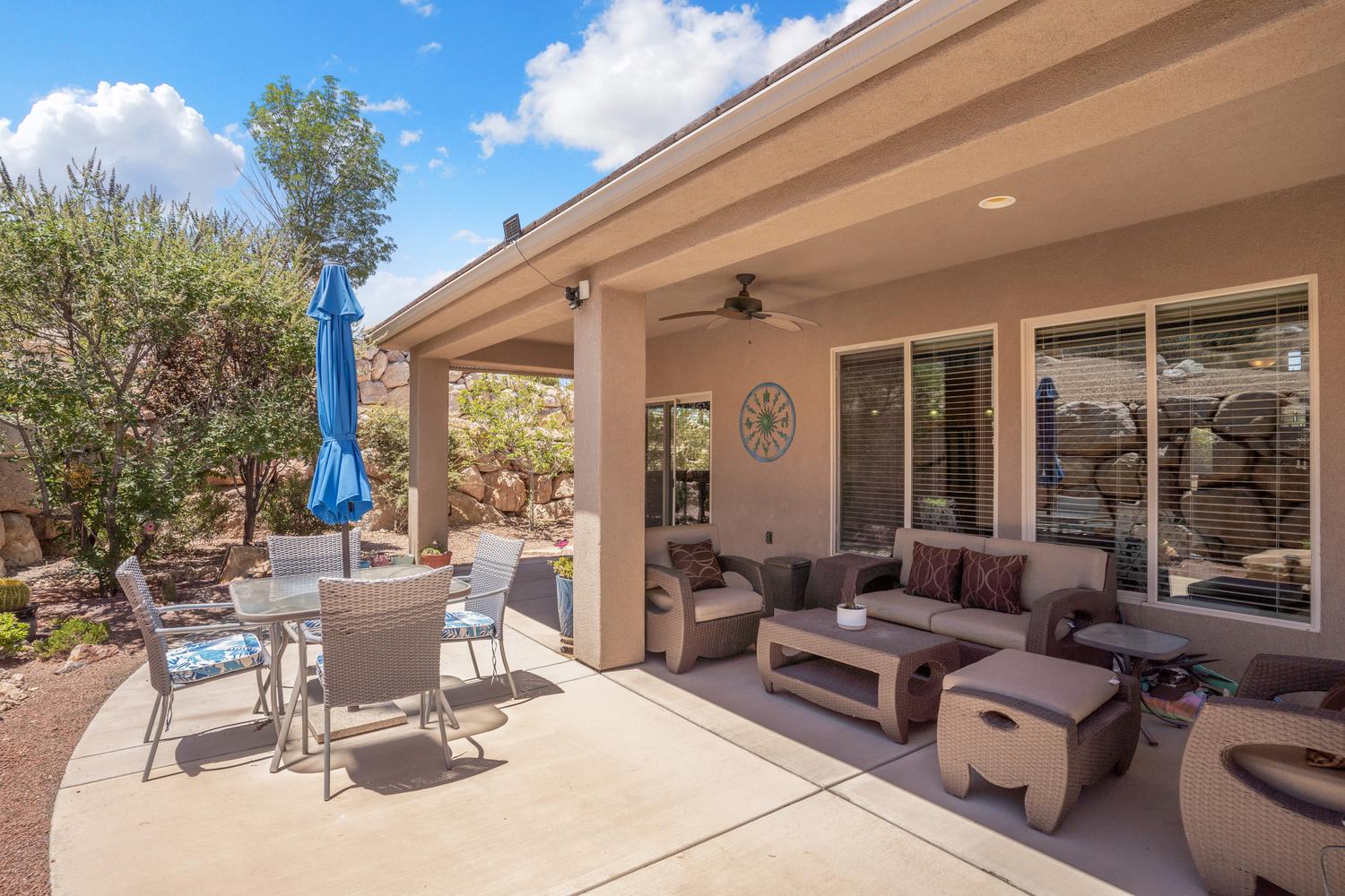 Spacious covered patio featuring a concrete surface and a ceiling fan
