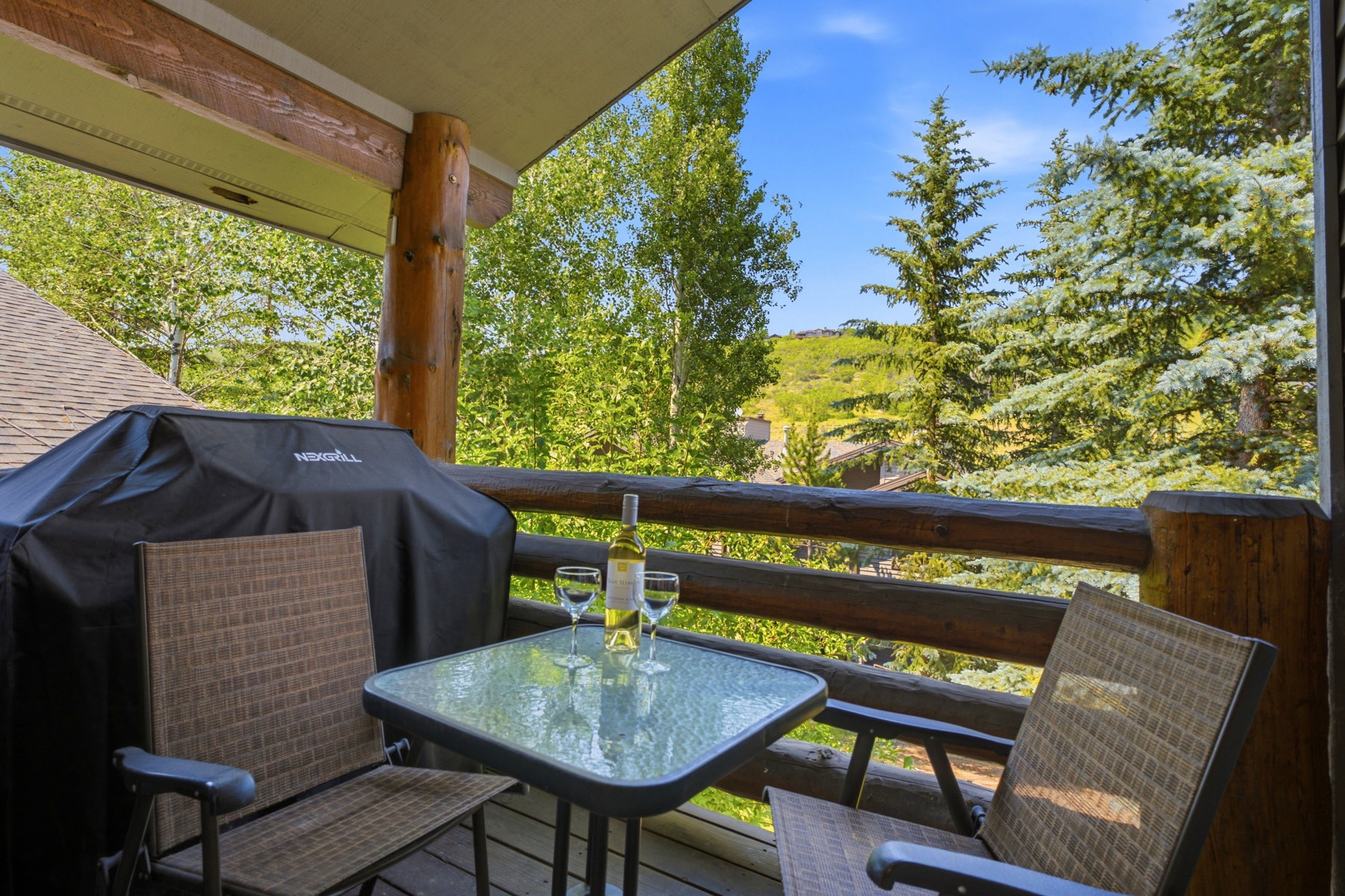 Outdoor balcony featuring a wood-finish railing and support posts