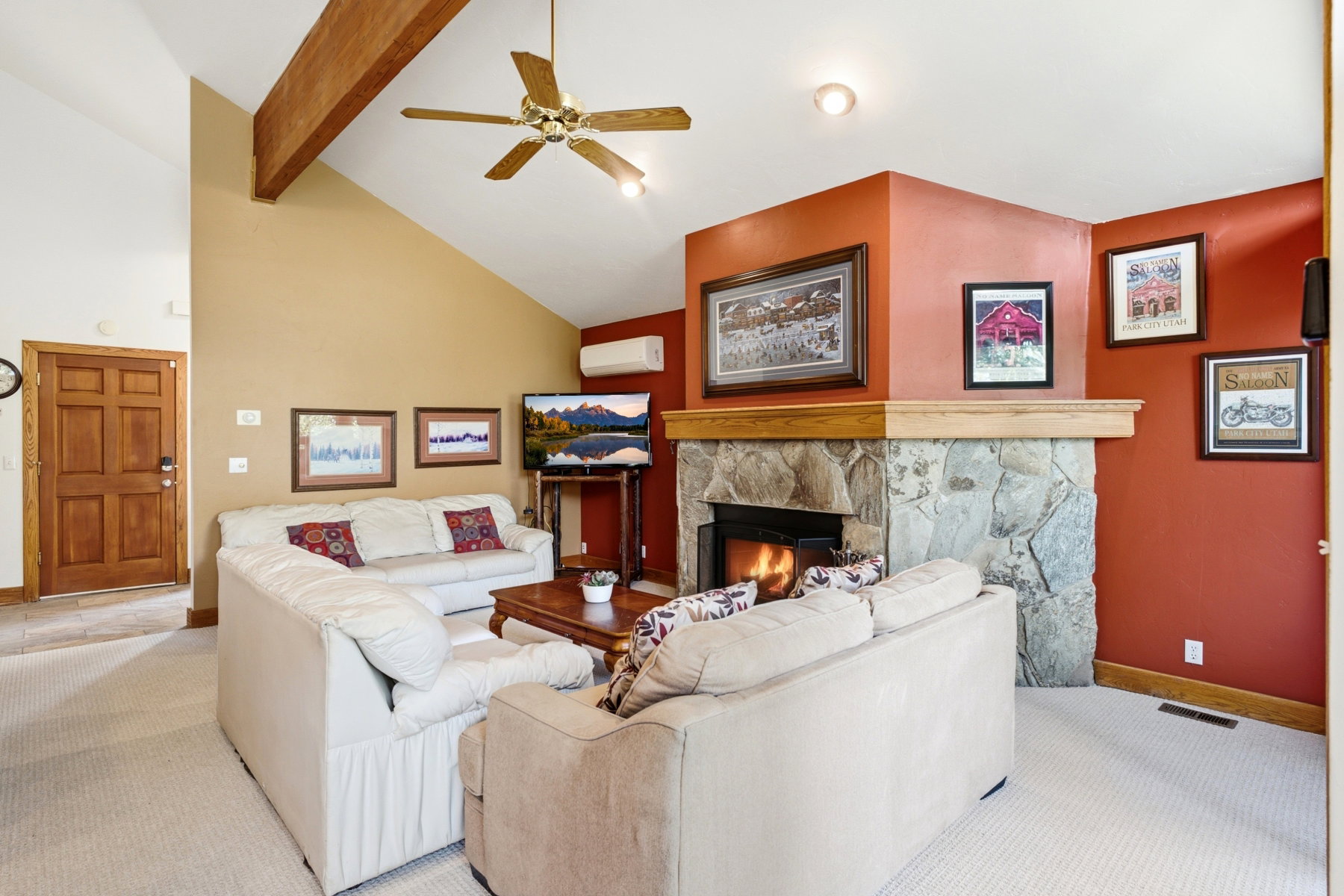 Living area featuring a vaulted ceiling with exposed wood beam, a ceiling fan, and recessed lighting