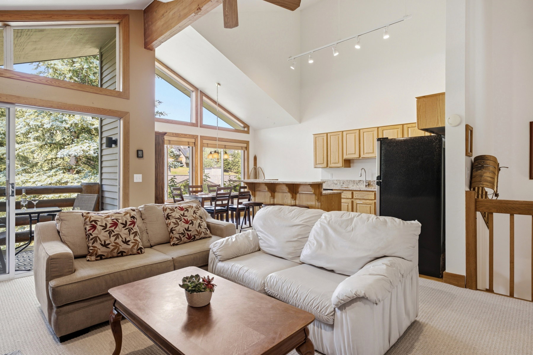 Vaulted ceilings with exposed wood beams in this open-concept living area