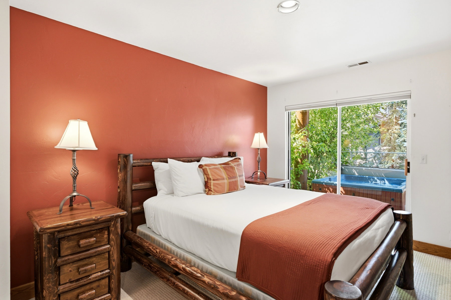 Bedroom featuring a sliding glass door providing access to a private patio with an integrated spa
