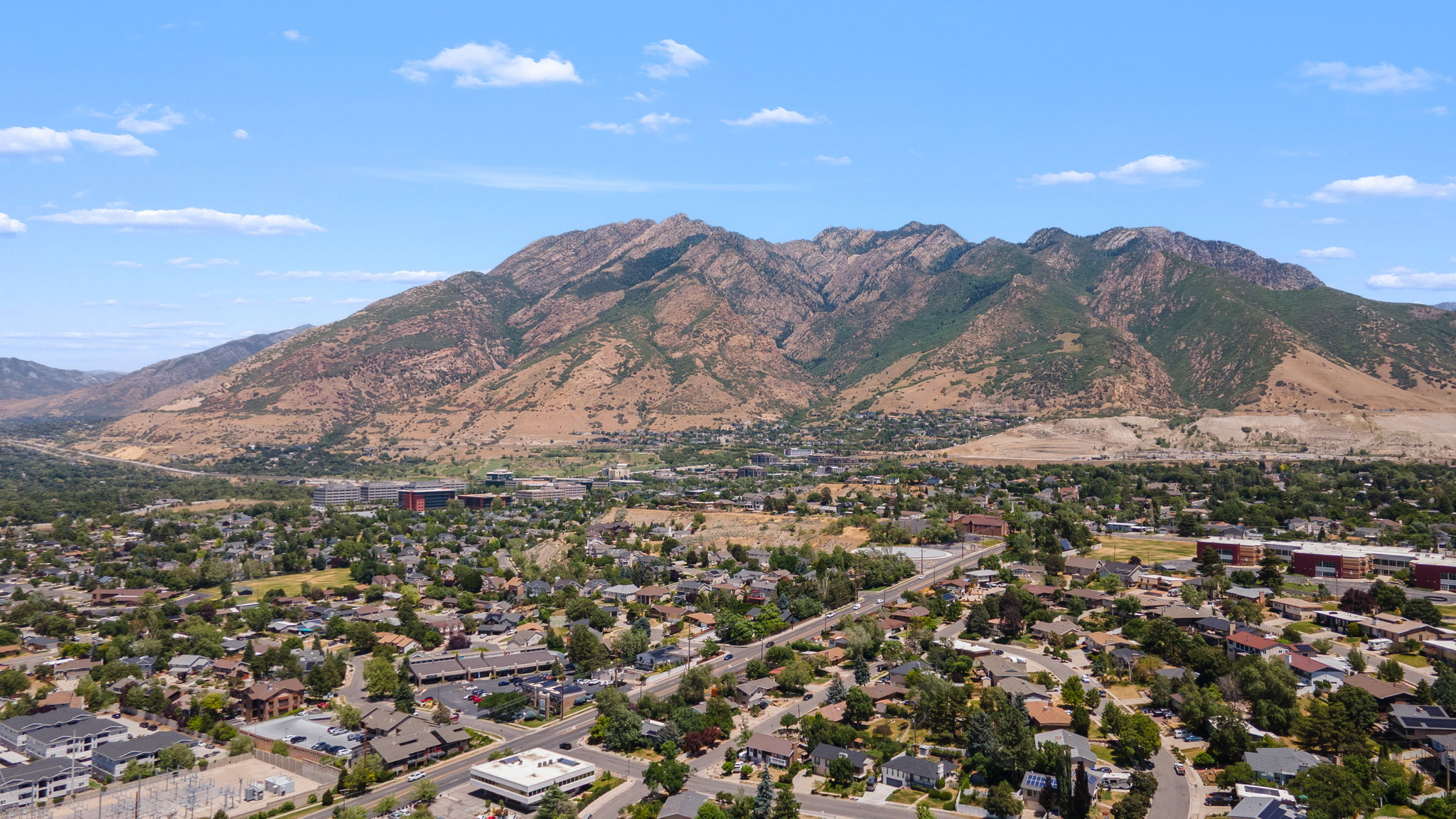 Expansive mountain range backdrop framing a residential landscape