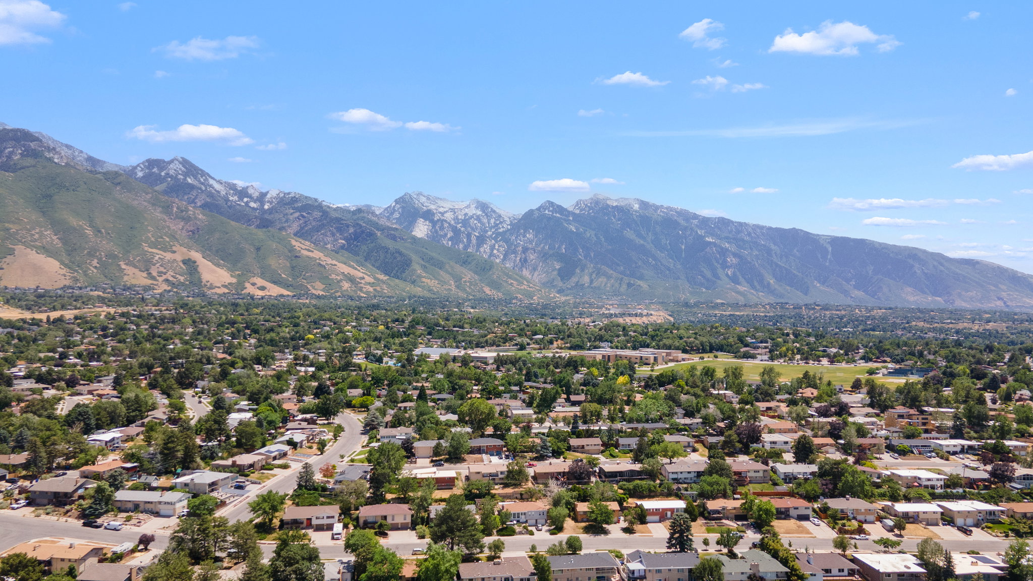 Expansive aerial perspective showcasing a residential neighborhood with varied architectural styles