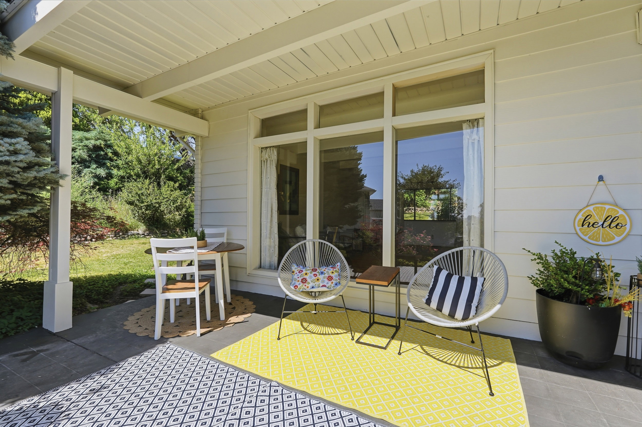 Covered patio with a smooth concrete slab and white horizontal siding