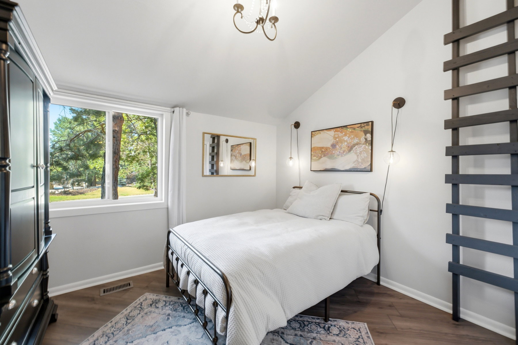 Bright room featuring a vaulted ceiling and a large window