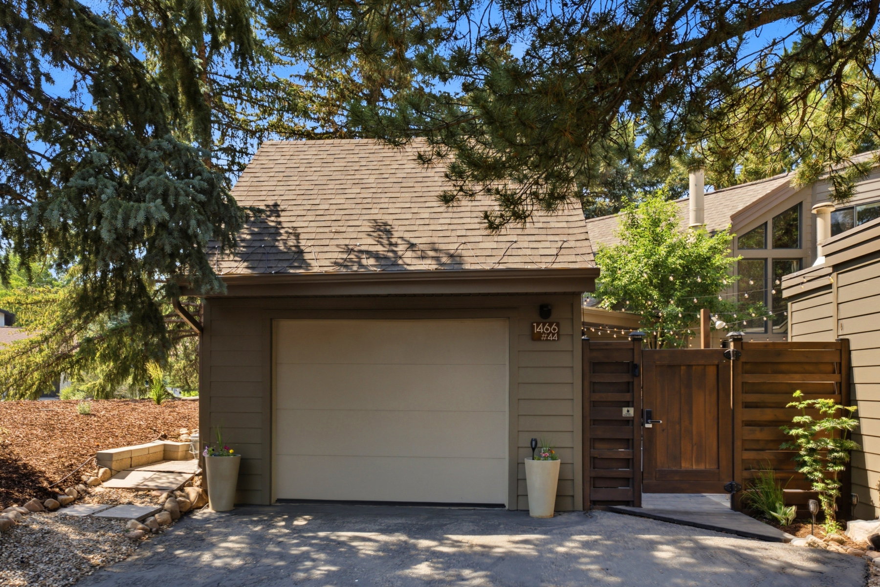 Attached garage with a tan overhead door and coordinating siding