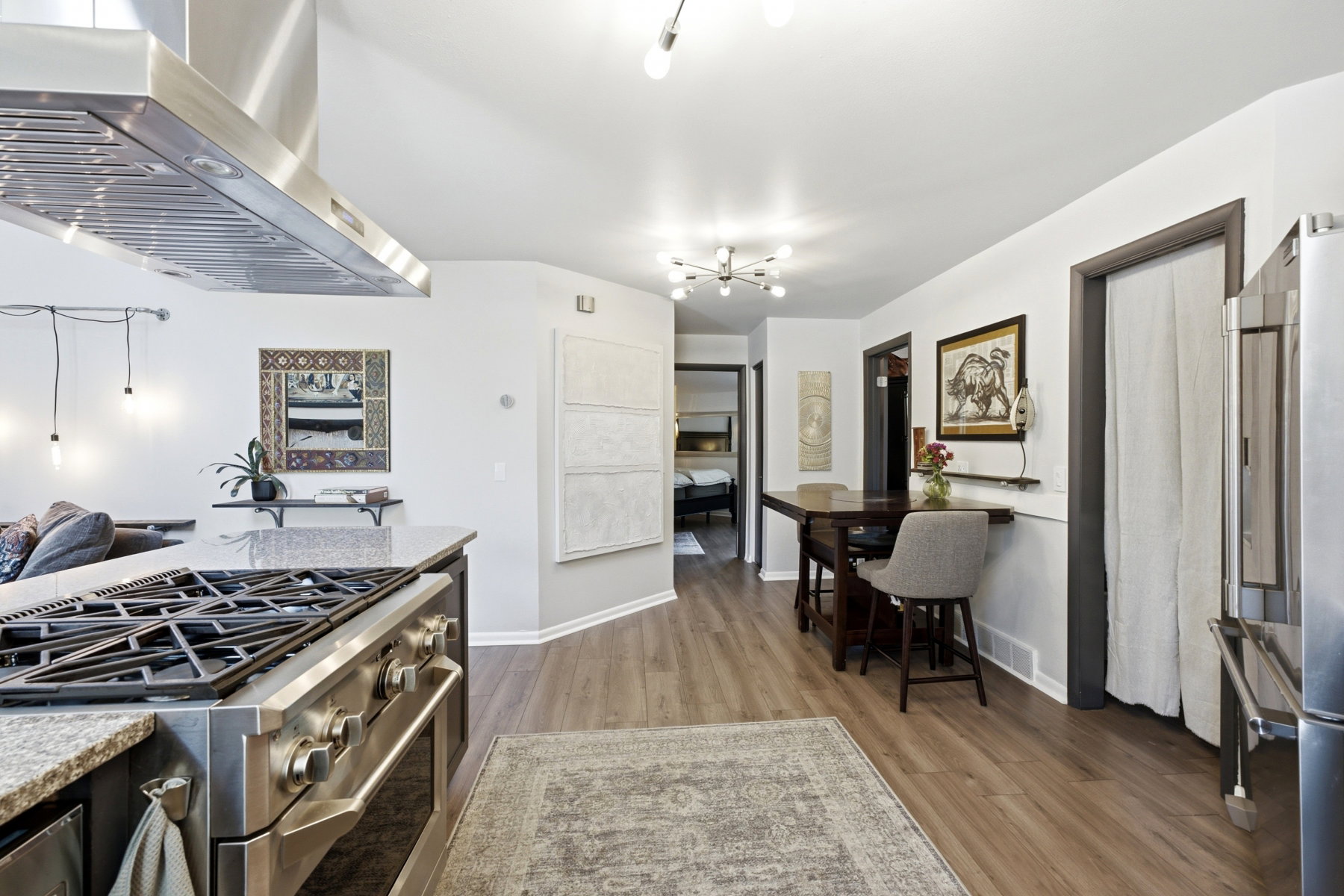 Gourmet kitchen with professional-grade stainless steel range and coordinating exhaust hood