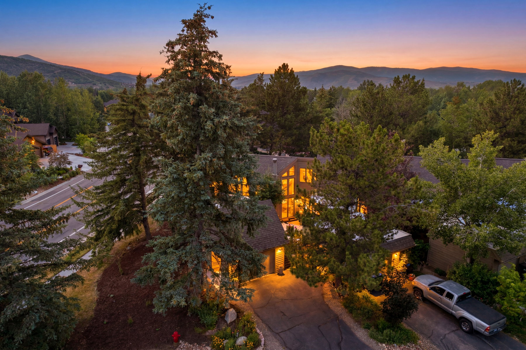 Mountain-style residence featuring a multi-level roofline, extensive window arrays, and a prominent peaked central section