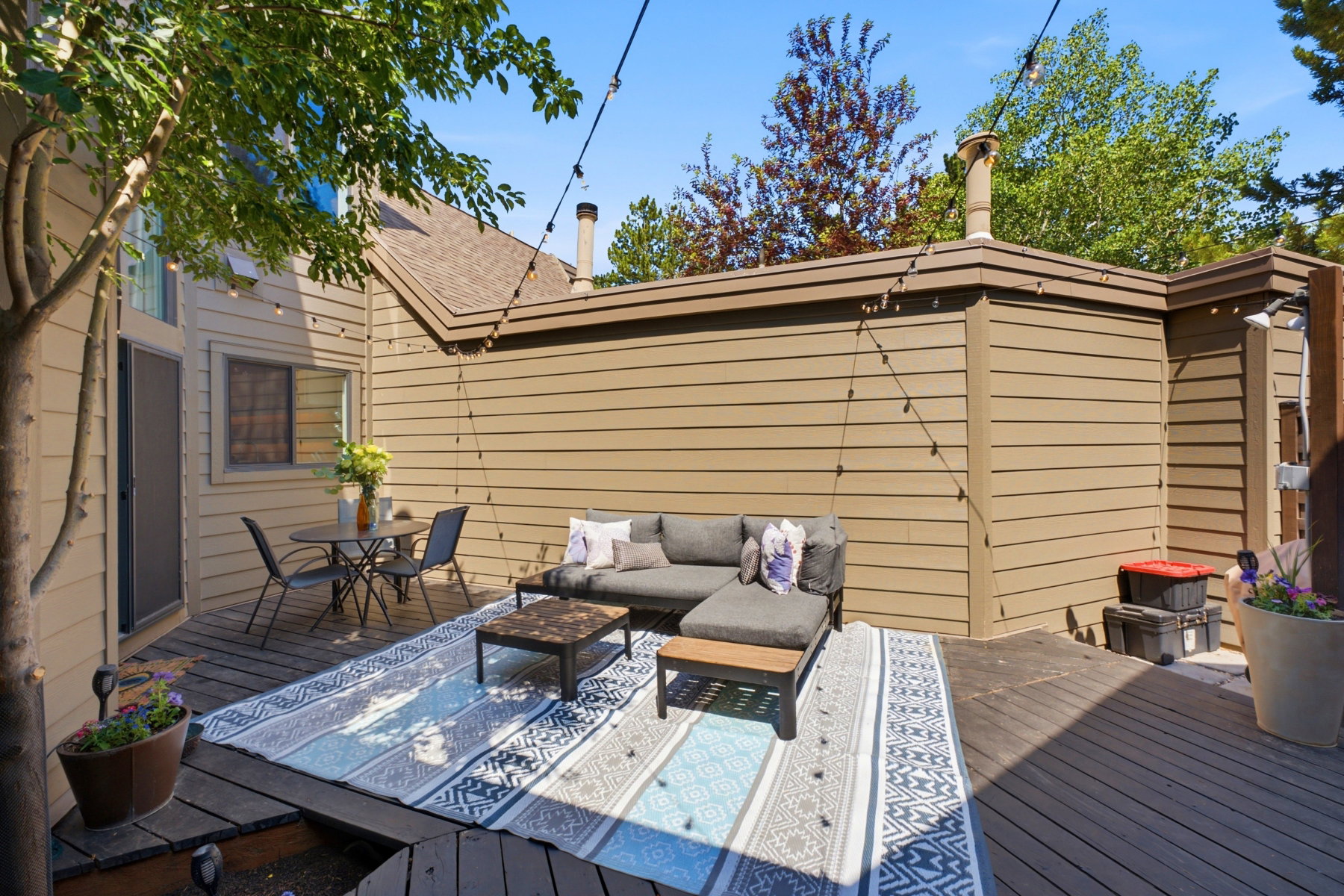 Expansive outdoor deck area featuring wood decking and integrated landscaping