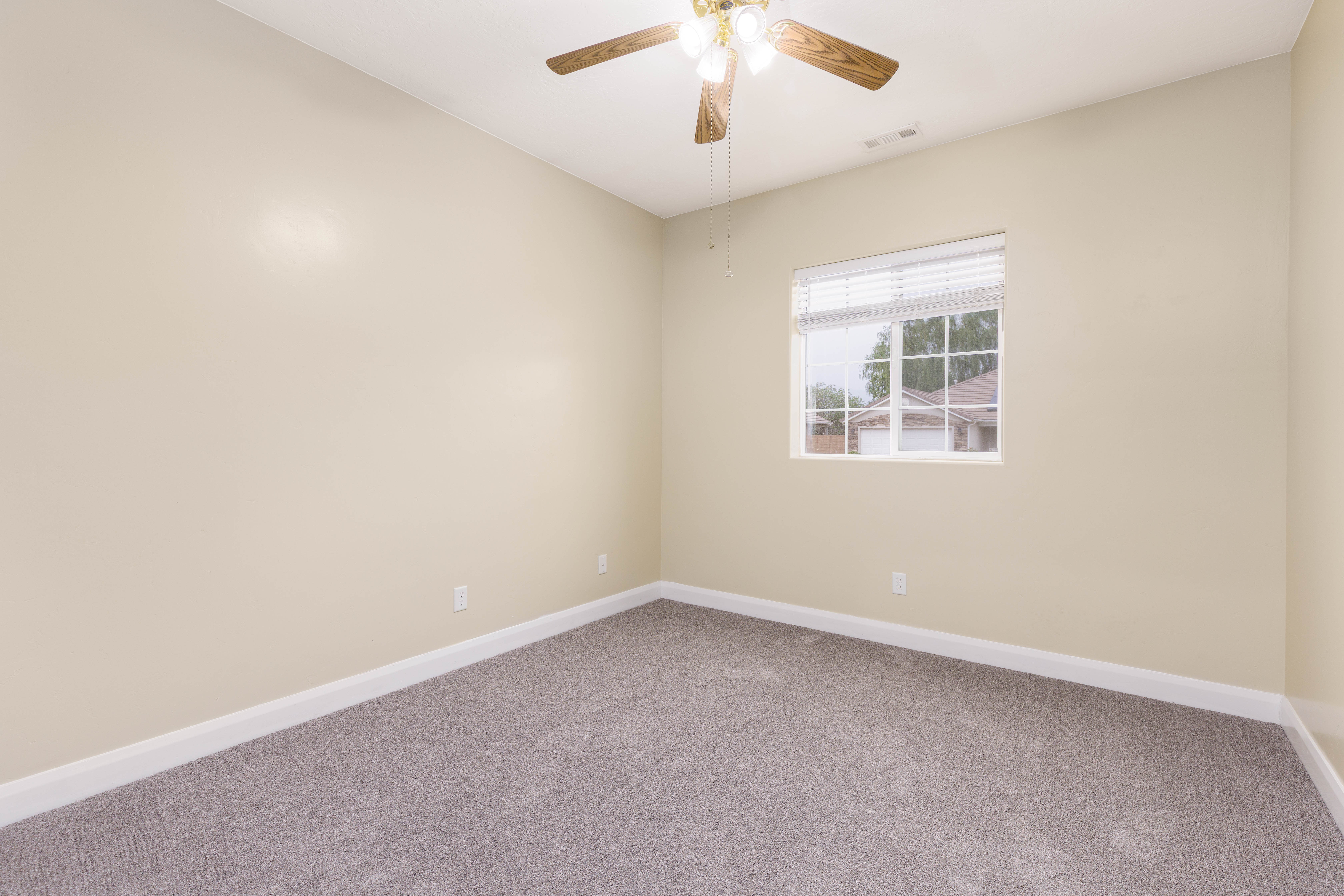Neutral-toned walls complement the grey carpeted flooring