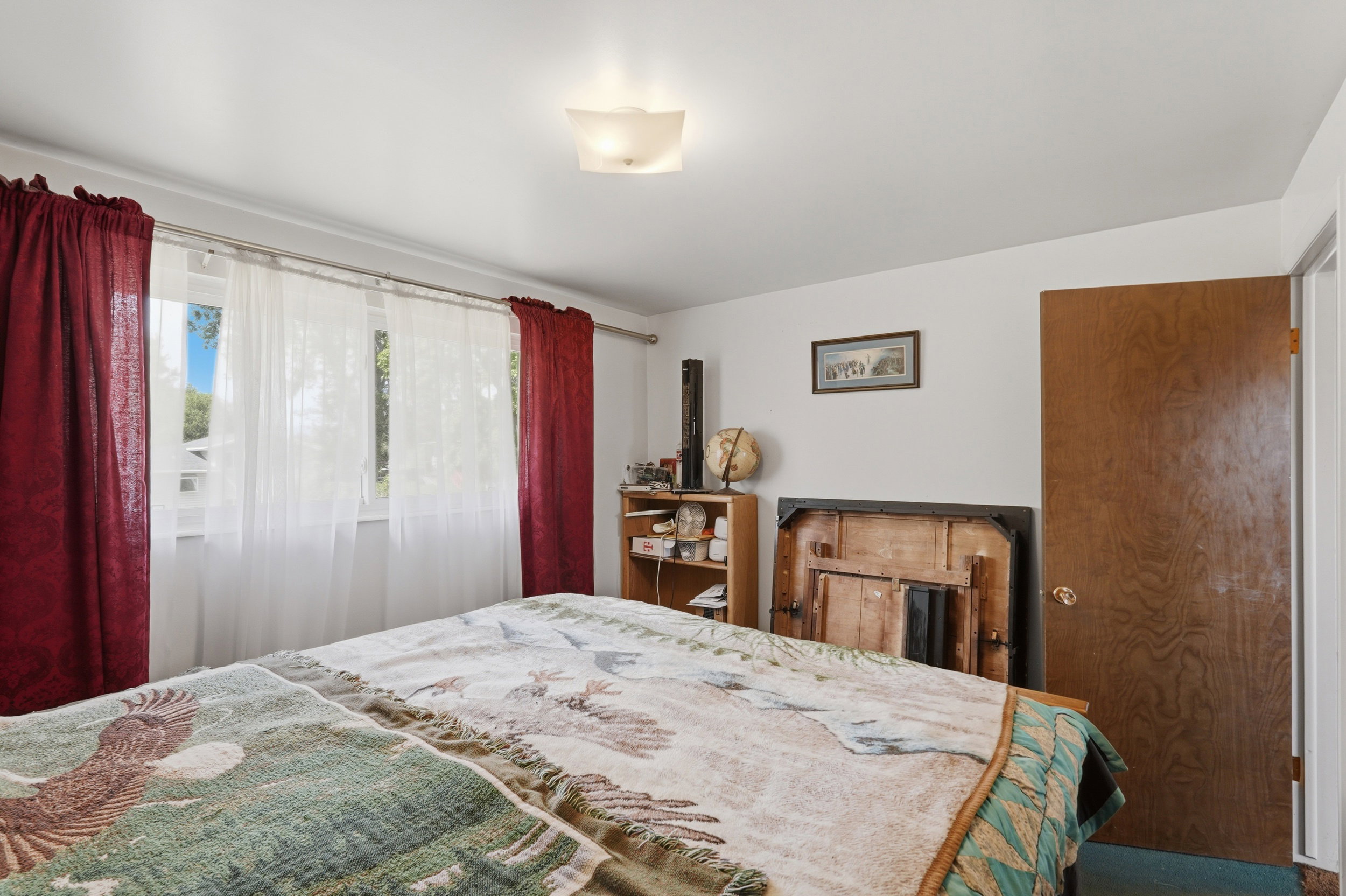 Room featuring wall-to-wall carpeting, white painted walls, and a ceiling-mounted light fixture