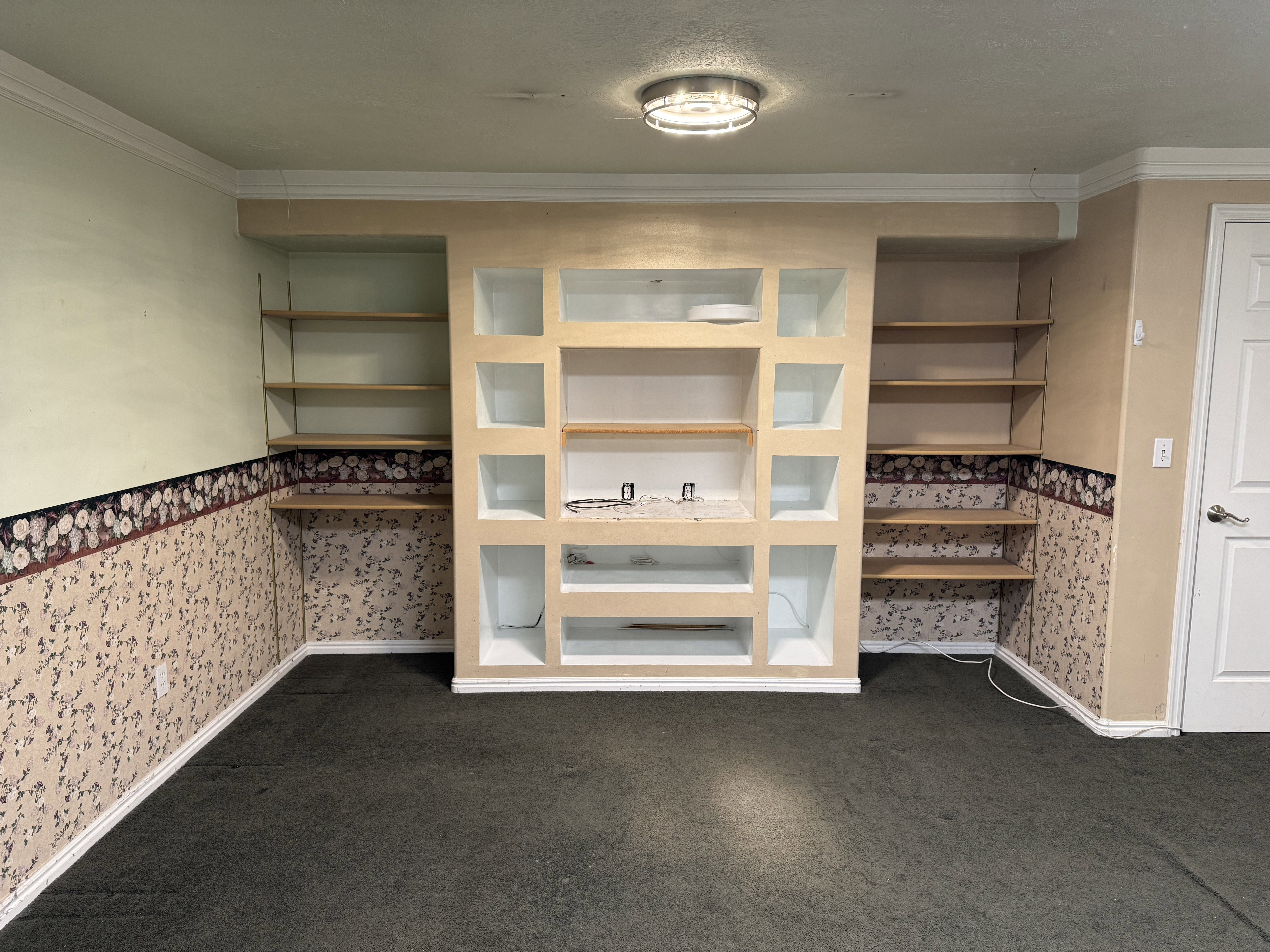 Built-in entertainment center featuring multiple display niches and open shelving