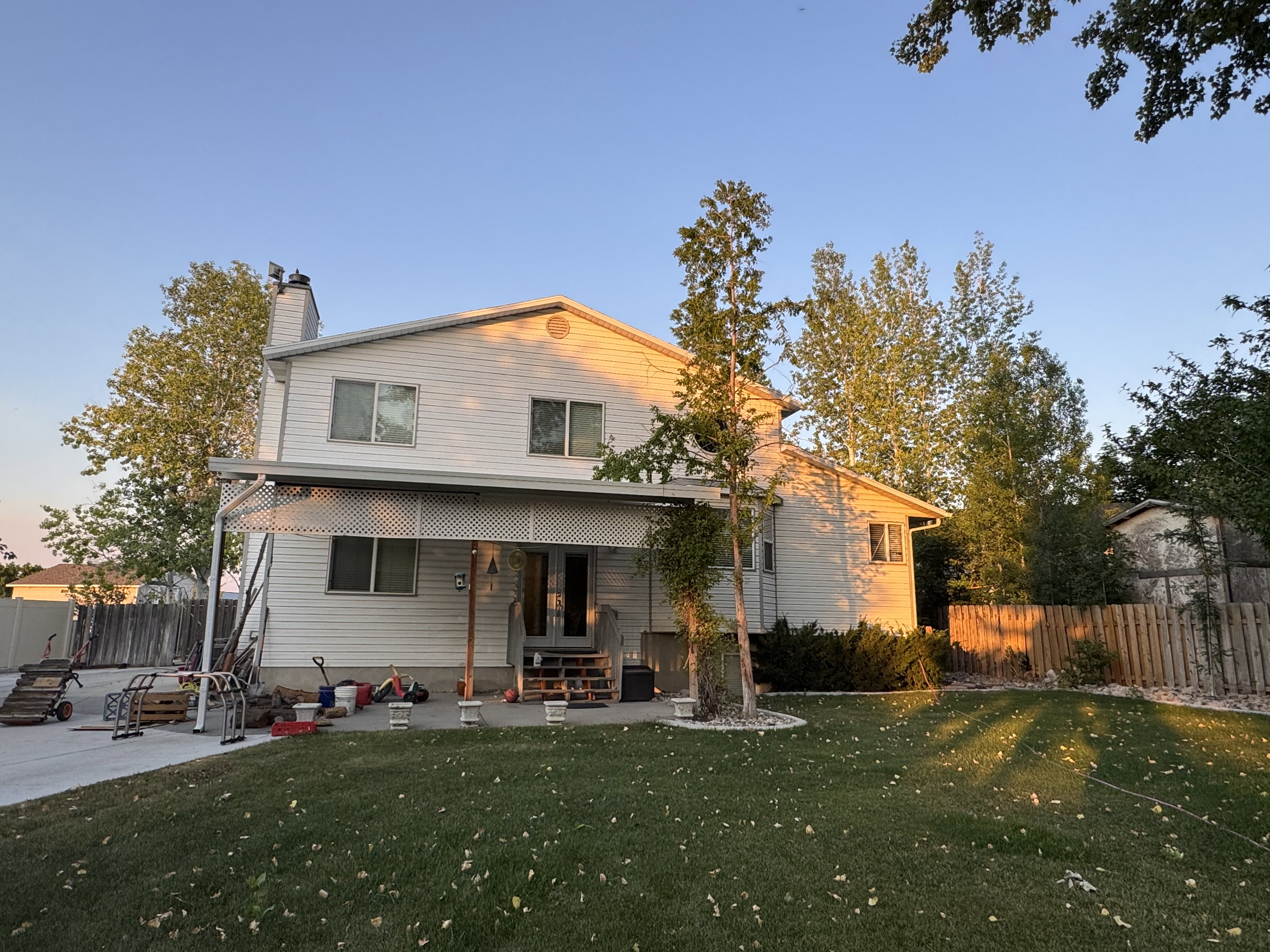 Back view: Two-story residence featuring Stuco and siding and a covered patio area