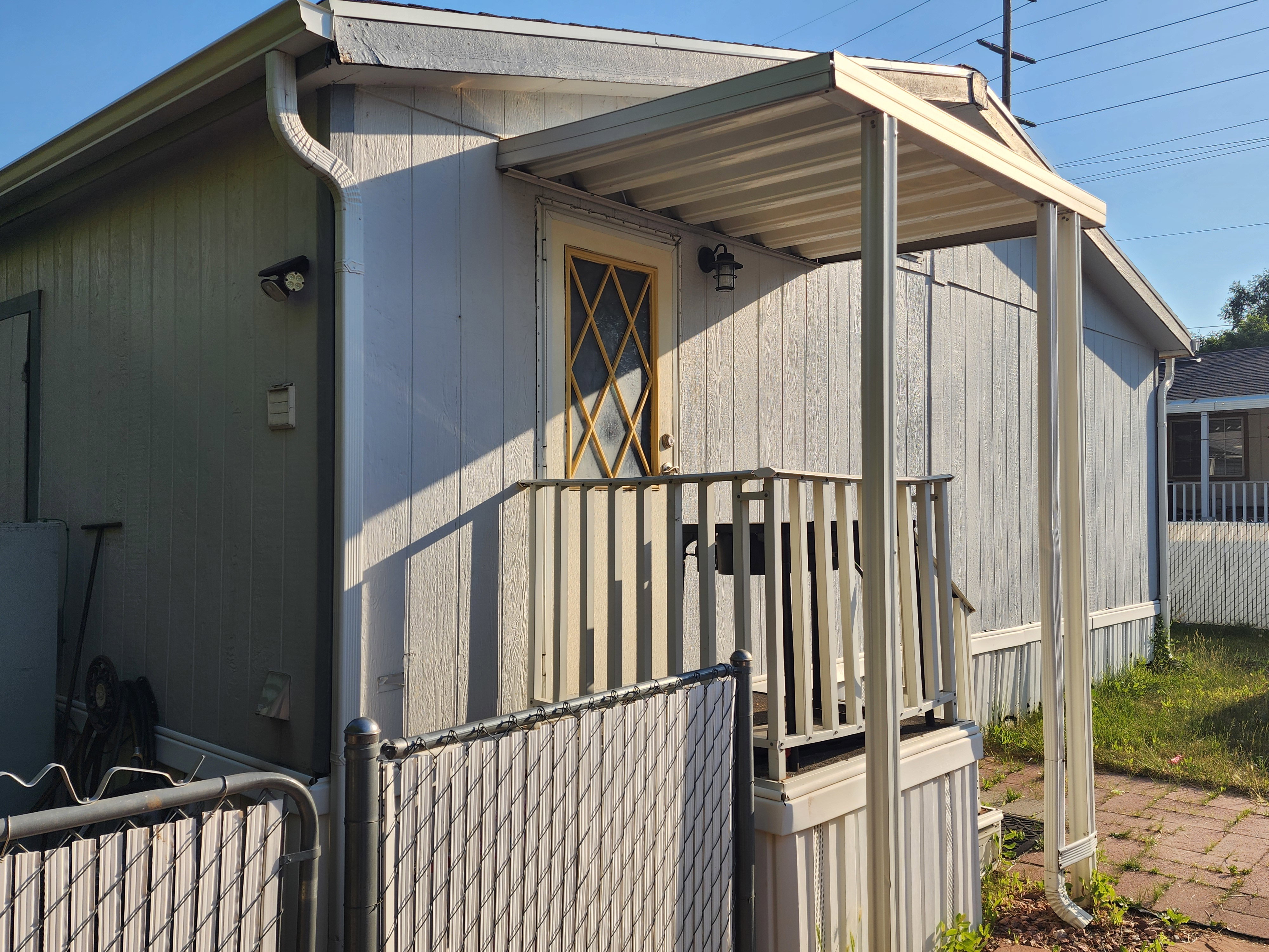 Front exterior featuring light blue siding and a covered porch