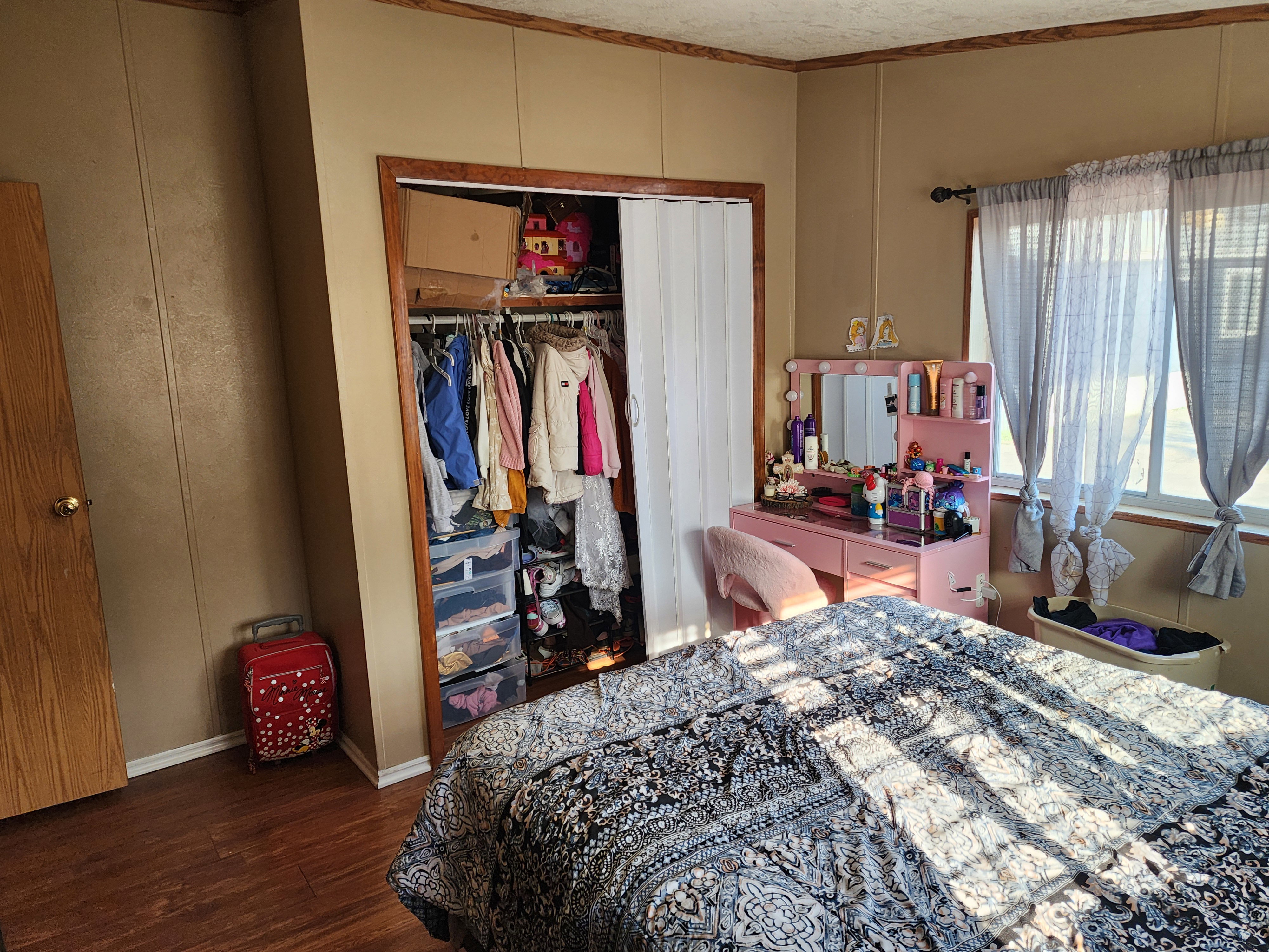 Wood-finish flooring with a neutral wall color and wood trim