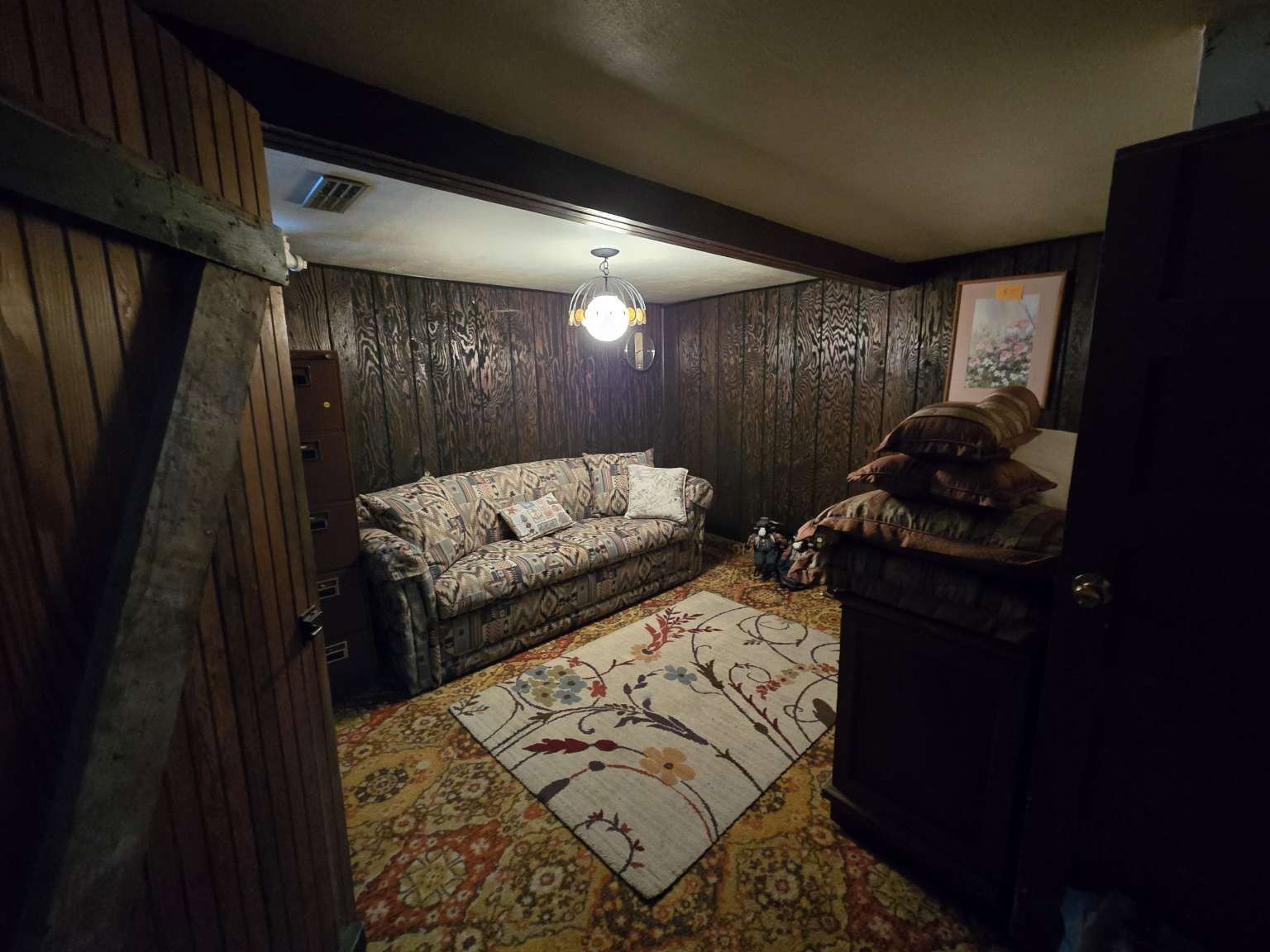 Room featuring wood-finish paneling and an overhead light fixture