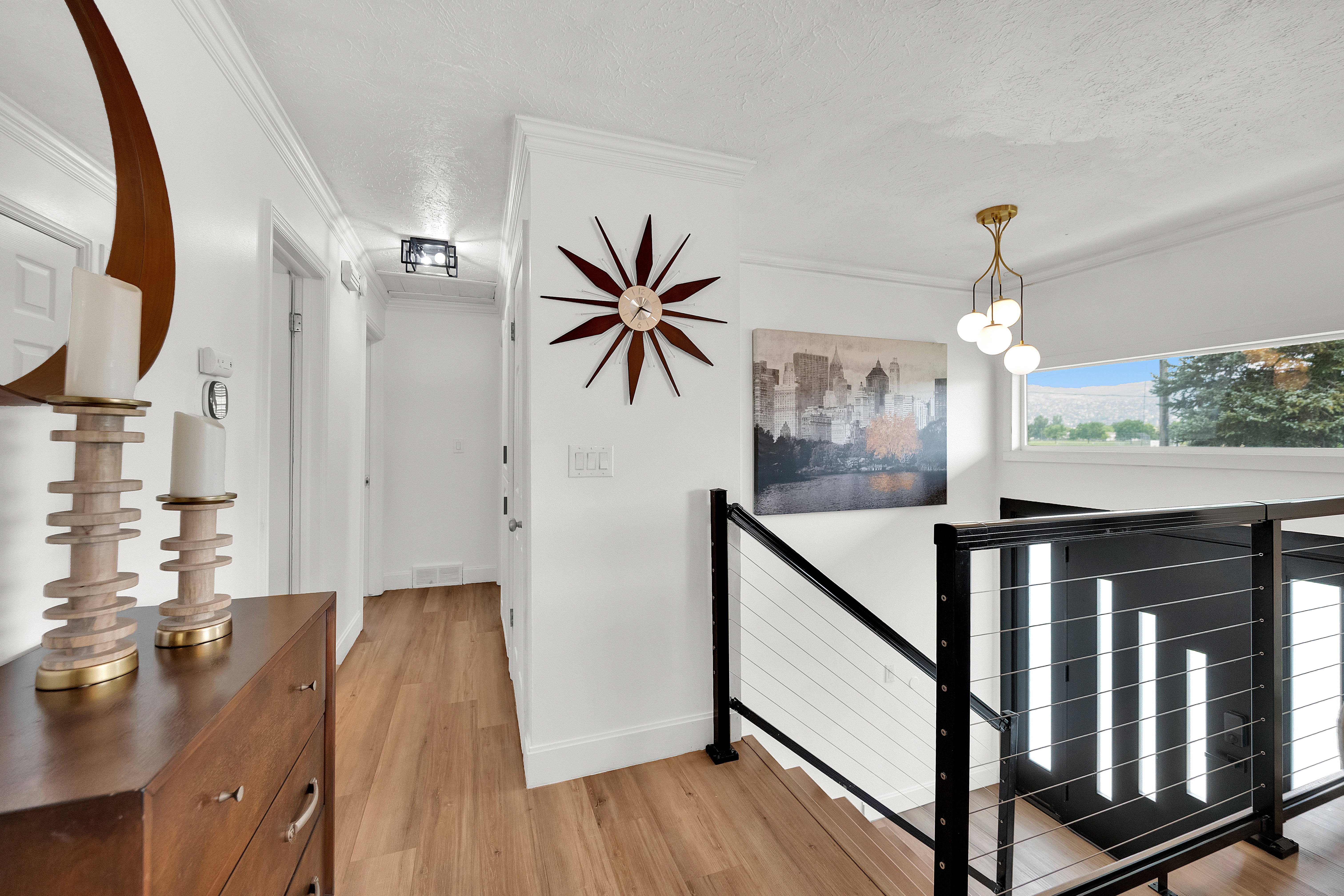 Modern stairwell featuring black metal railings with cable infill