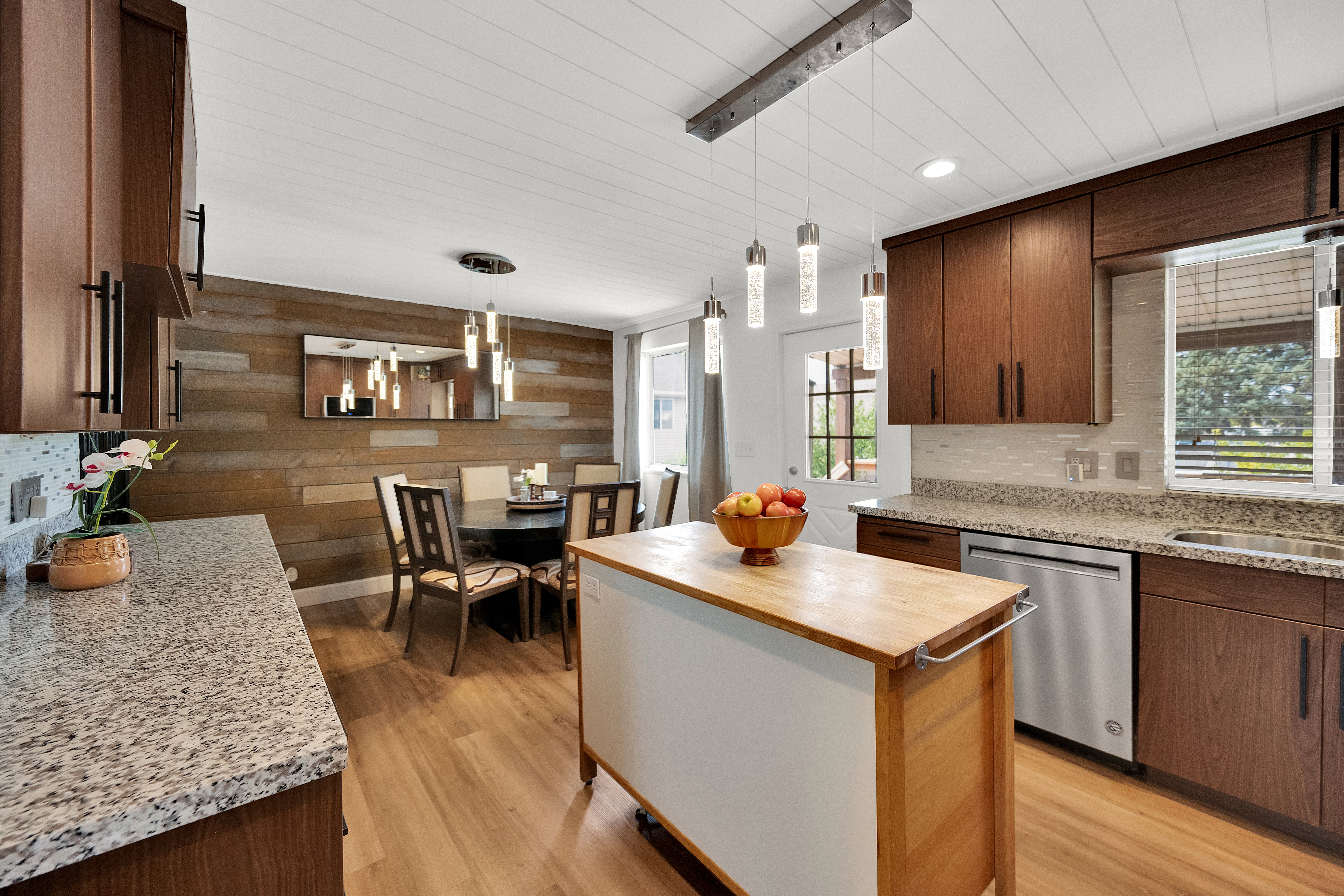 Kitchen featuring rich wood cabinetry, granite countertops, and a full suite of stainless steel appliances including a dishwasher
