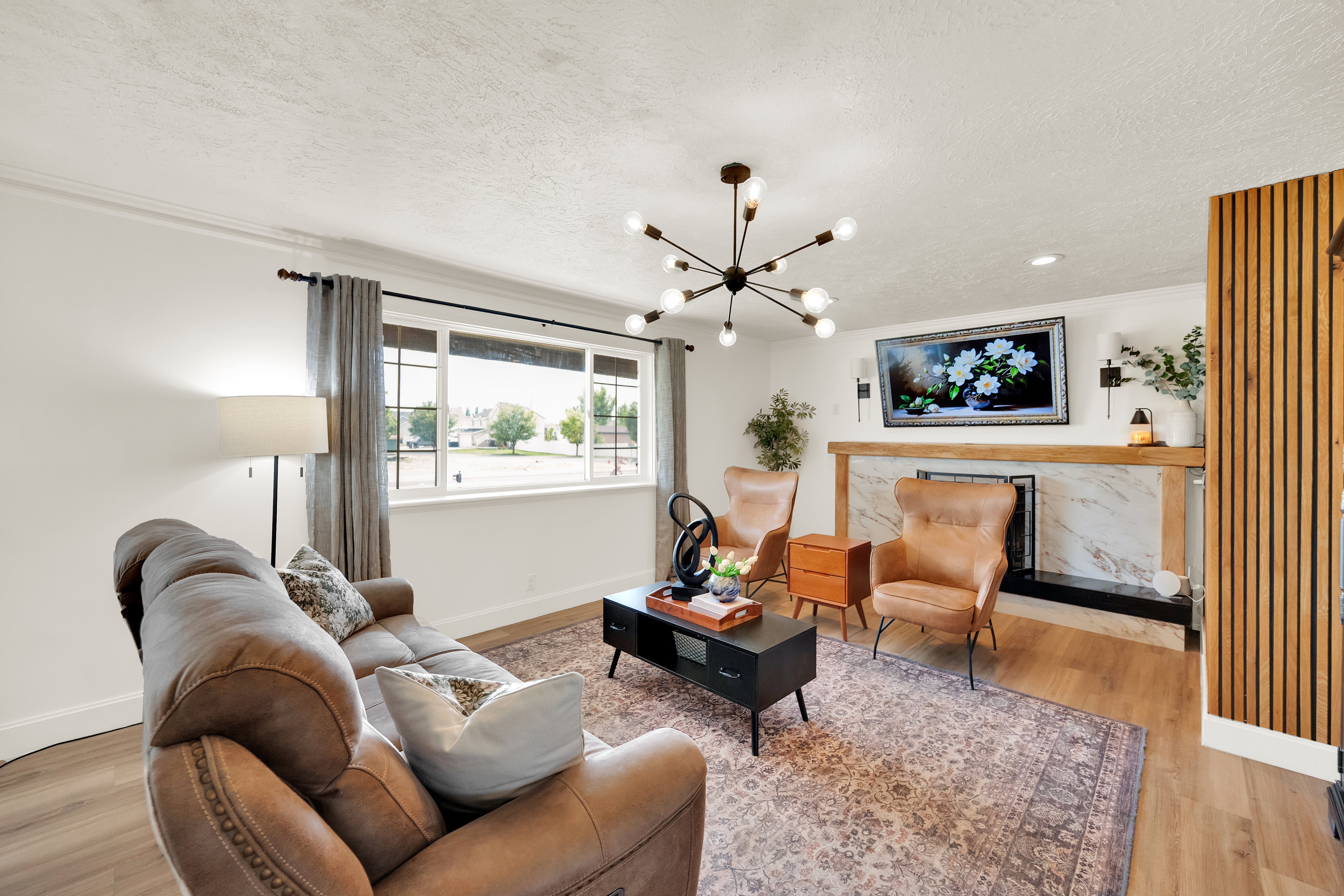 Living area featuring wood-finish flooring and a central chandelier