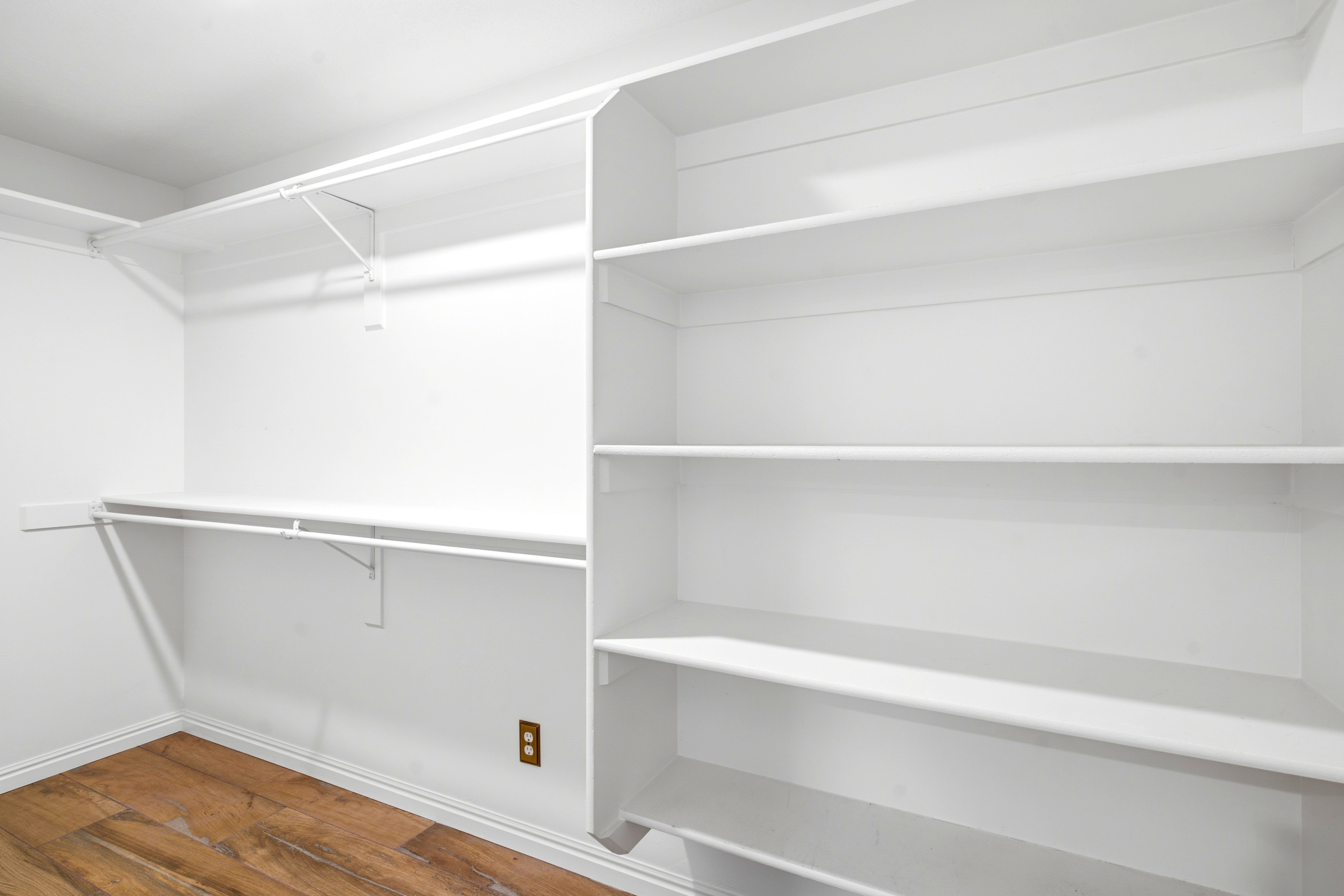Walk-in closet featuring built-in shelving.