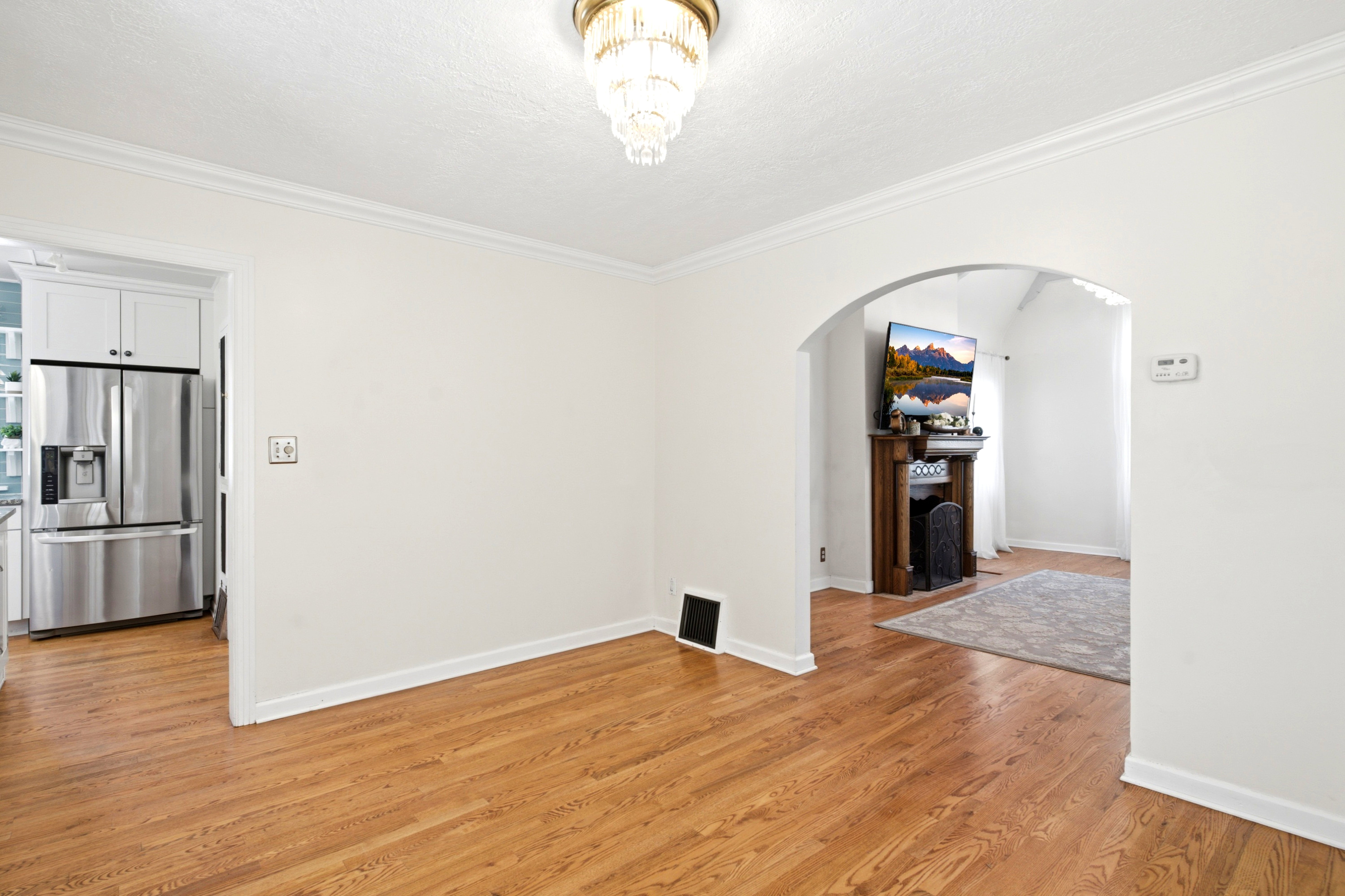 Classic Chandelier and hardwood flooring.
