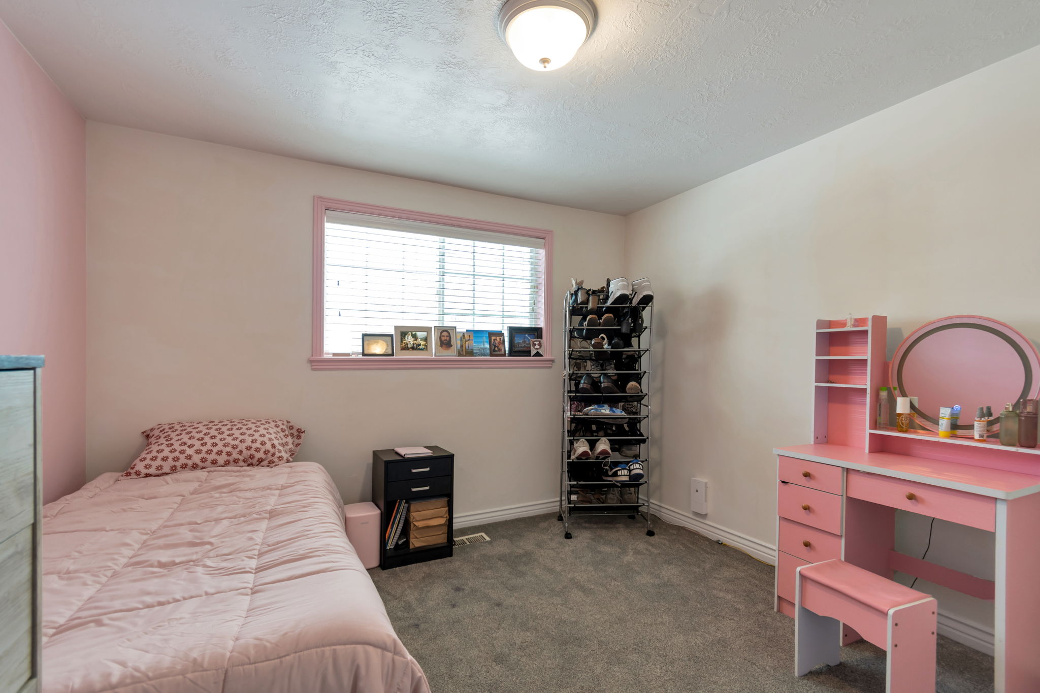 Bedroom featuring neutral wall colors, a single window with blinds, and gray carpet flooring