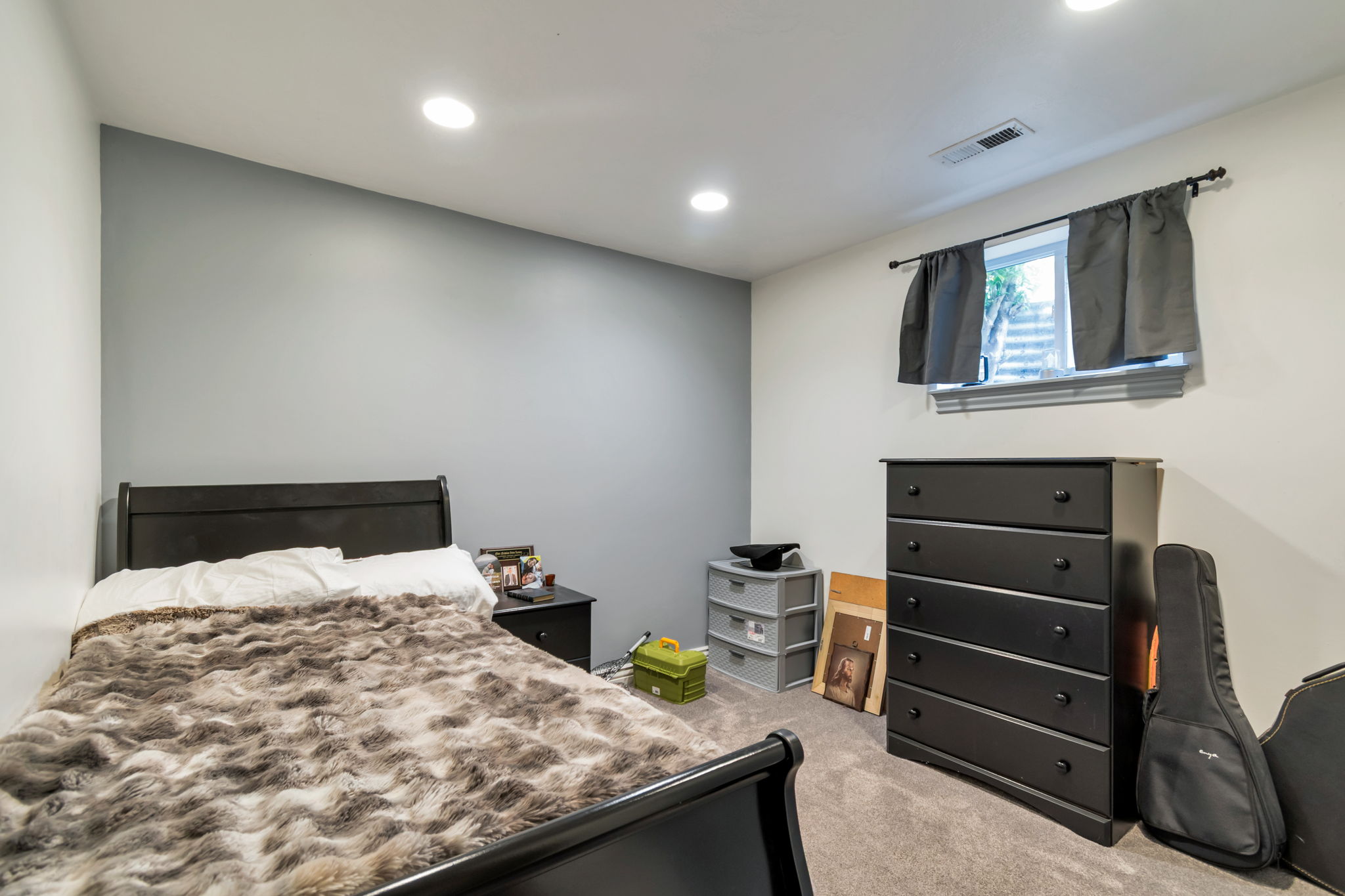 Carpeted room featuring recessed lighting and a window with a curtain rod