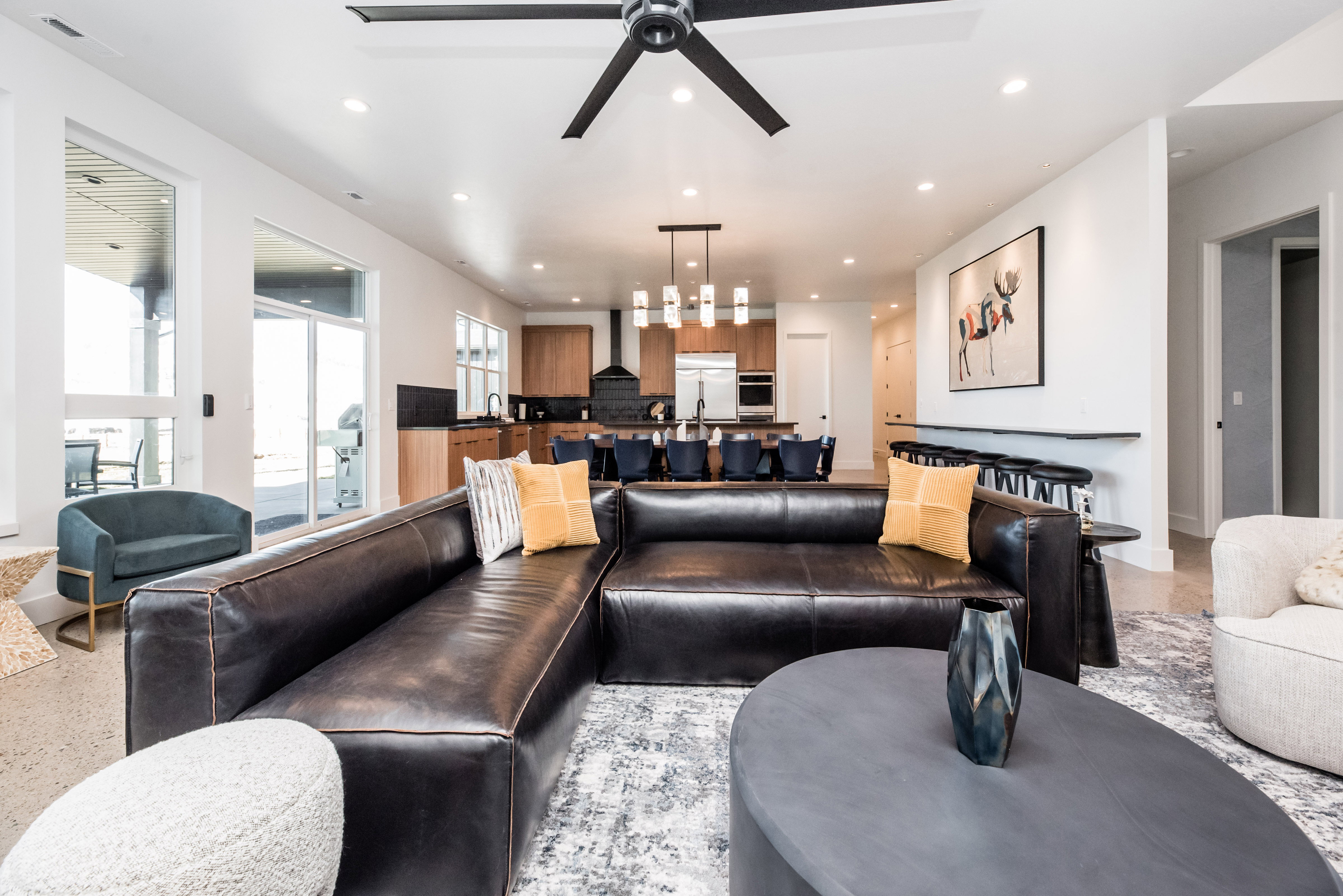 Open-concept living space featuring a modern ceiling fan, recessed lighting, and large sliding glass doors