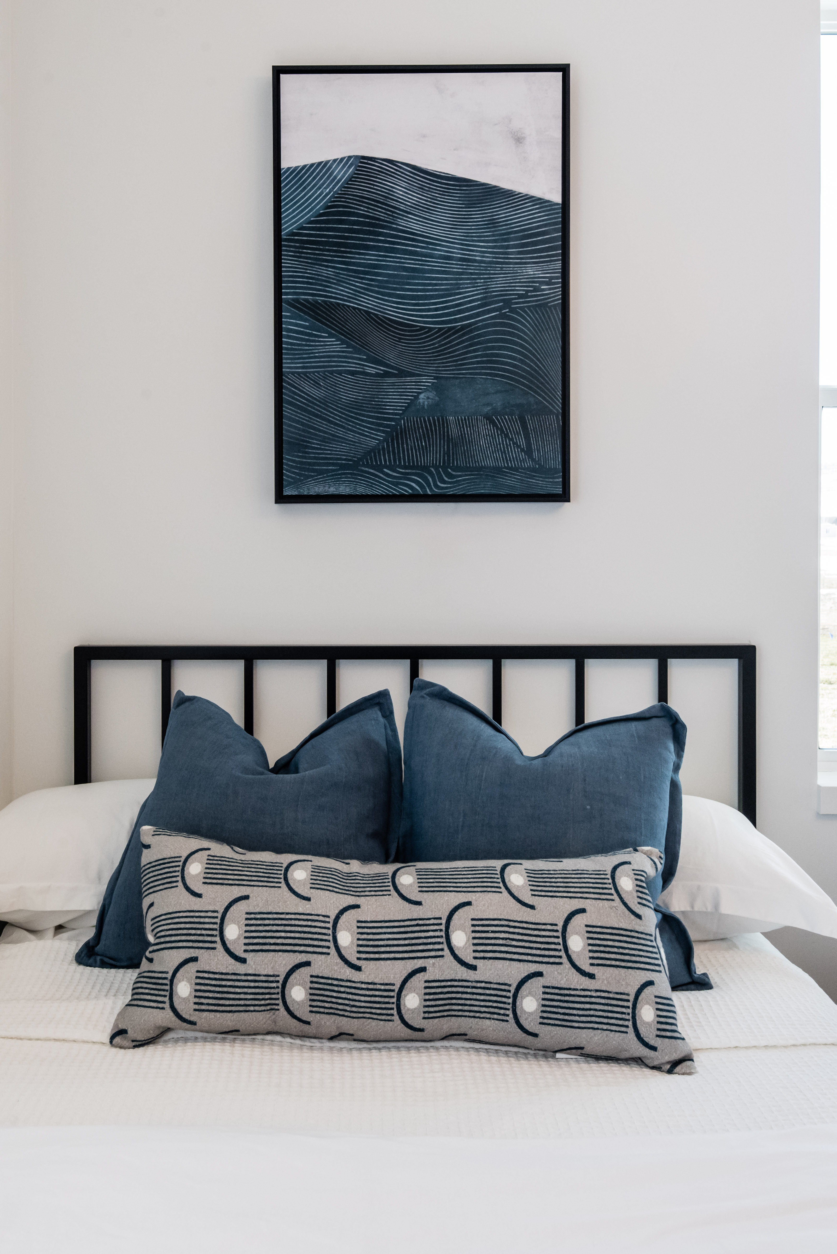 White wall space featuring a framed wall art piece